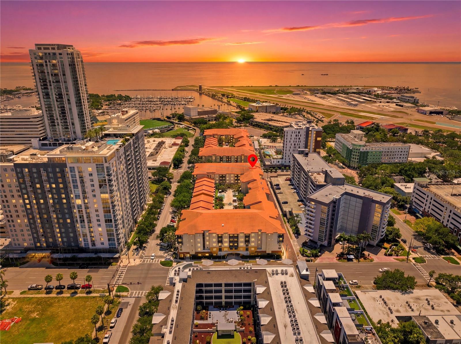 Some homes you tour. This one you settle into. From the first morning, Unit 410 at the Madison gives you the feeling of being exactly where you want to be, in the heart of downtown St. Petersburg, with a level of walkability that changes how your days flow. The car stays parked. Dinner, the waterfront, a gallery, a coffee, a long walk with your dog: all of it is on foot from your front door.
The home itself is a top-floor corner residence, which means no neighbors above you and natural light arriving from two exposures all day long. Step onto the private balcony and the partial view of Tampa Bay greets you, with a sunrise that becomes part of your routine rather than a rare treat. Inside, the layout simply works. The split floor plan tucks the primary suite away as a private retreat, complete with an ensuite bath and a walk-in closet, while the second bedroom sits apart and adapts to whatever your life needs, whether that is a focused home office, a comfortable guest room, or both.
The renovation, completed in recent years, was done with care you can feel. The kitchen brings together blue cabinetry and a deep walk-in pantry that keeps daily life easy and organized. The two bathrooms are finished in clean subway tile. Hurricane impact windows run throughout, and beyond the storm protection, they bring a calm and a quiet that make the whole home feel like a place to breathe. High ceilings open the rooms up, luxury vinyl flooring flows underfoot, and the original post and archway were preserved rather than torn out, giving the home a character that newer build-outs lose.
If you have a dog, you will feel the difference here. This is a dog-friendly building that welcomes larger dogs, set on streets made for walking, with waterfront parks close enough that your dog will learn the route by heart. It is the kind of place where a quick walk turns into a slow one because the surroundings are worth lingering in.
Life day to day is refreshingly simple. Parking is covered and assigned, the building is gated and secure with elevator access, and the monthly HOA covers cable, internet, water, insurance, and exterior maintenance, so your costs stay predictable and your time stays yours. The community adds a saltwater pool, a spa, a fitness center, and outdoor grilling areas for the easy moments.
If you have been searching for a move-in ready home that combines real walkability, a dog-friendly setting, privacy, a water view, and the ease of low-maintenance downtown living, Unit 410 is the one to come see in person.