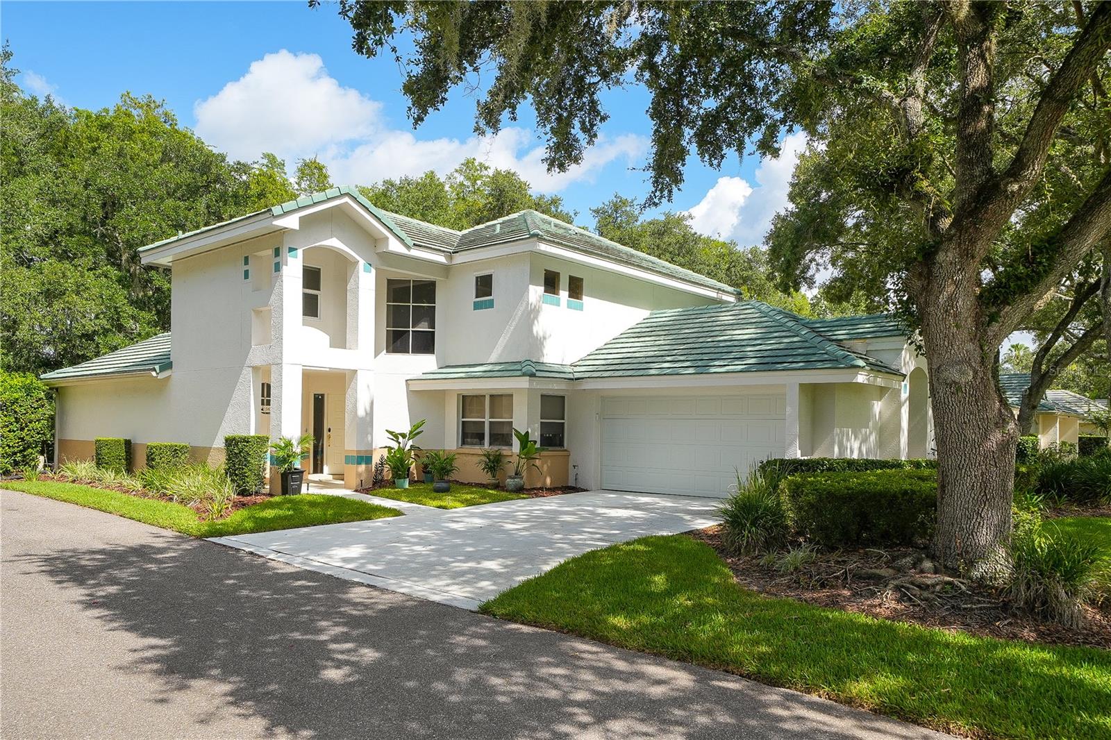 Towering beauty located in The Sanctuary of Tampa Palms, Idyllic private gated community within Tampa Palms lined with Grandfather Oaks, offering all the freedom of a single family home without the headaches of maintenance, yes lawn, and exterior house painting is included (edging, trimming, lawn service, fertilization, irrigation as well as exterior paint on all of the homes)i!    Pride of ownership is evident from the moment you enter through the gates of this community! Home is  nestled on a cul-de-sac, conservation premium lot with towering oaks.  
From the moment you walk in the front door, you will notice the updated luxury wood-look resilient flooring throughout as well as a spacious well distributed floor plan with towering ceilings.  You won't want to miss seeing the spacious gourmet kitchen (updated in 2020 ) complete with quartz counter tops and state of the art kitchen appliances,  overlooking the dining  and formal areaa , making this a great home for entertaining! Step into the spacious family room with towering ceilings with sun roof panels providing natural lighting during the day, which overlooks the spacious patio and in-ground spa and beautiful conservation back drop views!!   Owners suite is located on the first level,  also open to and overlooking the spa and conservation back drop, and boasts an elegant remodeled bath with stylish "barn" door entry, stone counter tops, double sinks, over sized walk in shower with dual heads, bench seating and full body jets. Head over to the second floor and you will be greeted by a spacious loft , great for office or play area!  The remainder of the rooms are on the second level and offer lots of windows with neighborhood and conservation views! Double car garage has electric "EV " charging station. The list goes on and on, there are so many upgrades to mention!!  Best of all it is just a short walk to the Tampa Palms Country Club with Championship Golf Course , Community pool, Clay Tennis Courts, athletic facilities, and dining options. Also In close proximity to schools, shopping, dining, not to mention medical facilities, as well as USF and Moffitt, Only 30 minutes to downtown Tampa. You must see to appreciate everything this beautiful and stately home has to offer.....but you better hurry , this home will not last, and is competitively priced to sell fast!!