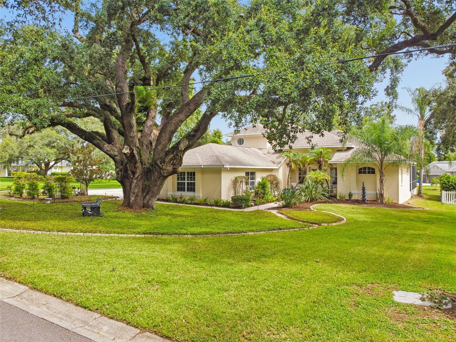 This extraordinary custom-built pool home offers spectacular Lake Valrico views, stunning sunsets, a superb floor plan, a fully enabled smart home system, an outdoor kitchen, a newly renovated kitchen, updated bathrooms, and a prime location in a hidden enclave of custom-built, stately homes in the heart of Valrico. Thoughtfully designed throughout, the home features custom built-in closets, ceiling fans in most rooms, split living areas, split bedrooms, and a hidden safe. From the moment you arrive, you’ll feel the natural beauty and peaceful setting of this one-of-a-kind Lake Valrico residence. Located in an “X” flood zone, the home does not require flood insurance, has no HOA, and did not flood during the 2024 storms. This truly special home is a must-see. The formal living room welcomes you with high ceilings, sliding doors framing pool and lake views, multiple seating areas, and a natural White Oak acoustic slat wood panel added by the music-loving sellers for both visual texture and sound absorption. The updated kitchen features wood cabinetry, quartz countertops, a huge walk-in pantry with built-in shelves, drawers, and tool storage, plus all-new appliances, including an induction range, GE Profile convection microwave, GE Profile dishwasher, and KitchenAid 23.8 cu. ft. 36-inch counter-depth refrigerator. The dining room features a gas fireplace and creates an inviting gathering space for friends and family. Custom built-ins provide surround sound, space for electronics, and generous additional storage. This home was truly designed for both entertaining and relaxing.
The first-floor primary suite is spacious and bright, with door leading to the pool. The primary ensuite features walk-in closets, an updated double vanity with a backlit mirror, a custom shower, garden tub, and a separate water closet with additional storage and shelving. One of the home’s most delightful features is the **Dedicated Walk-in Accessory Closet**- perfect for organizing handbags, shoes, hats, belts, and all the extras you'll want to complete that perfect outfit. (SO Dreamy) Also on the first floor are the second bedroom, a beautifully updated guest bathroom with a walk-in shower, and an oversized laundry room with a new folding table, hanging rack, and abundant storage. In the garage, you’ll find a 5-by-10-foot air-conditioned room ideal for extra appliances or use as an office, studio, or workshop. The oversized garage also includes an air conditioning and heating unit and a garage door opener. Upstairs, you’ll find two additional spacious bedrooms with amazing lake views and stunning sunsets, an updated guest bathroom with a double vanity and shower/tub combination with new glass shower doors, an additional office space with a dry bar that could easily be converted to a kitchenette, and a lovely family room with some of the best views in the home.
Outside, multiple inviting spaces highlight the beautiful landscaping, including a pergola, fire pit, brick and stone pavers, and outdoor lighting. The outdoor Tuff Shed features a new roof, electricity, and full smart home system connectivity. The home also includes an owned water softener, and the cameras, surround sound, speakers, smart home, and security components will convey. Every detail has been thoughtfully completed, with no expense spared in making this one of the area’s most exceptional homes.