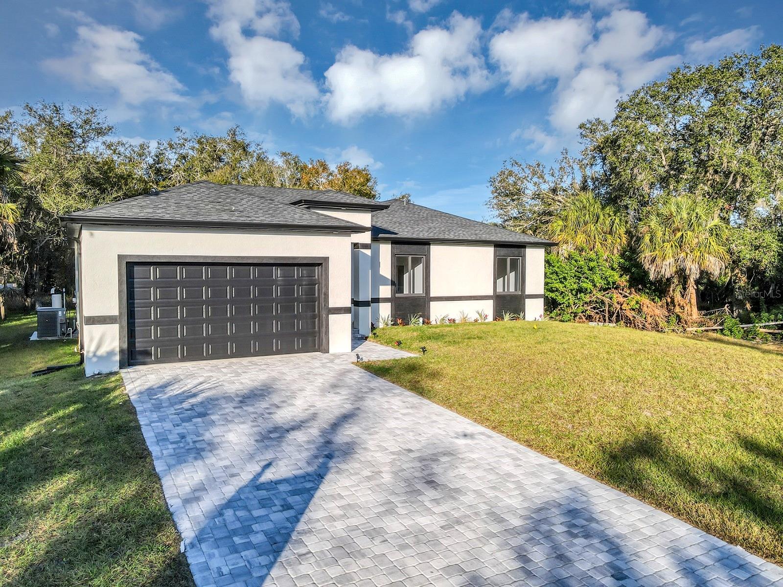 Virtually Staged. Stop scrolling, summer kitchen, 10-foot ceilings, and a 10-2 home warranty, plus $4,399.00 lender credit, free appraisal, and up to $5,000 in closing costs or rate buy-down assistance. This is the one that stands out. This brand-new 2026 construction offers 2,163 sq ft of thoughtfully designed living space, delivering a rare combination of modern design, functionality, and affordable luxury. From the moment you walk in, you'll notice the difference. With 10-foot ceilings, 8-foot interior doors, and a dramatic 16-foot sliding glass door, the home is filled with natural light and designed to feel open, elevated, and inviting. The layout is what truly sets this home apart. Designed for real life, it features a 3-zone split floor plan that offers both privacy and flexibility. The primary suite is privately positioned on one side of the home, while two secondary bedrooms are located on the opposite wing and share a Jack-and-Jill bathroom. In addition, a fully enclosed den with its own full bathroom provides the perfect setup for guests, a home office, or an in-law suite. The open-concept living area seamlessly connects the kitchen, dining, and living spaces, creating a natural flow for both everyday living and entertaining. The kitchen is designed with style and function in mind, featuring modern finishes and a spacious layout. Step outside to your covered lanai with a summer kitchen, creating the perfect space to relax, entertain, and enjoy Florida living year-round. This home also offers the opportunity to add a custom pool and spa, with a proposal already available for buyers who want to complete their own backyard retreat. Additional features include a whole-house water filtration system, irrigation system, spacious laundry room, and 2-car garage, all complemented by quality finishes throughout. Located in a quiet residential area of Port Charlotte, with convenient access to shopping, dining, schools, and Gulf Coast beaches. Homes with this level of design, layout, and incentives don't last. Schedule your showing today.