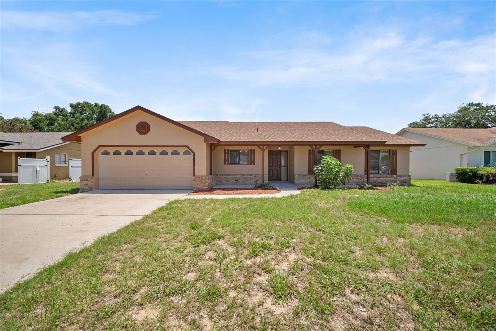 Virtually Staged. Move-in ready and refreshed from top to bottom! This 3-bedroom, 2-bath single-story home sits on nearly a quarter-acre lot on a quiet court in Orlando's sought-after 32835 zip code, just 5 minutes from the 408 for an easy commute to downtown Orlando and the attractions. Big-ticket items are done: ** BRAND NEW ROOF (2026)**, fresh interior and exterior paint throughout — including all doors, trim, baseboards, and the garage — plus a new vanity and sink in the primary bath. Inside, vaulted ceilings and tile flooring flow through a bright, open living and dining area with sliding doors to the backyard. The kitchen offers a breakfast nook and a convenient pass-through to the living room. A split floor plan gives the primary suite privacy, with a walk-in closet and en-suite bath. No carpets in the home! All rooms feature laminate flooring. Out back, the fully fenced backyard is HUGE — plenty of room for a pool, playset, pets, or entertaining. Oversized 2-car garage, covered front porch with brick accents. Close to MetroWest, Valencia College, shopping, and dining. Homes with this much already done don't last — schedule your showing today!