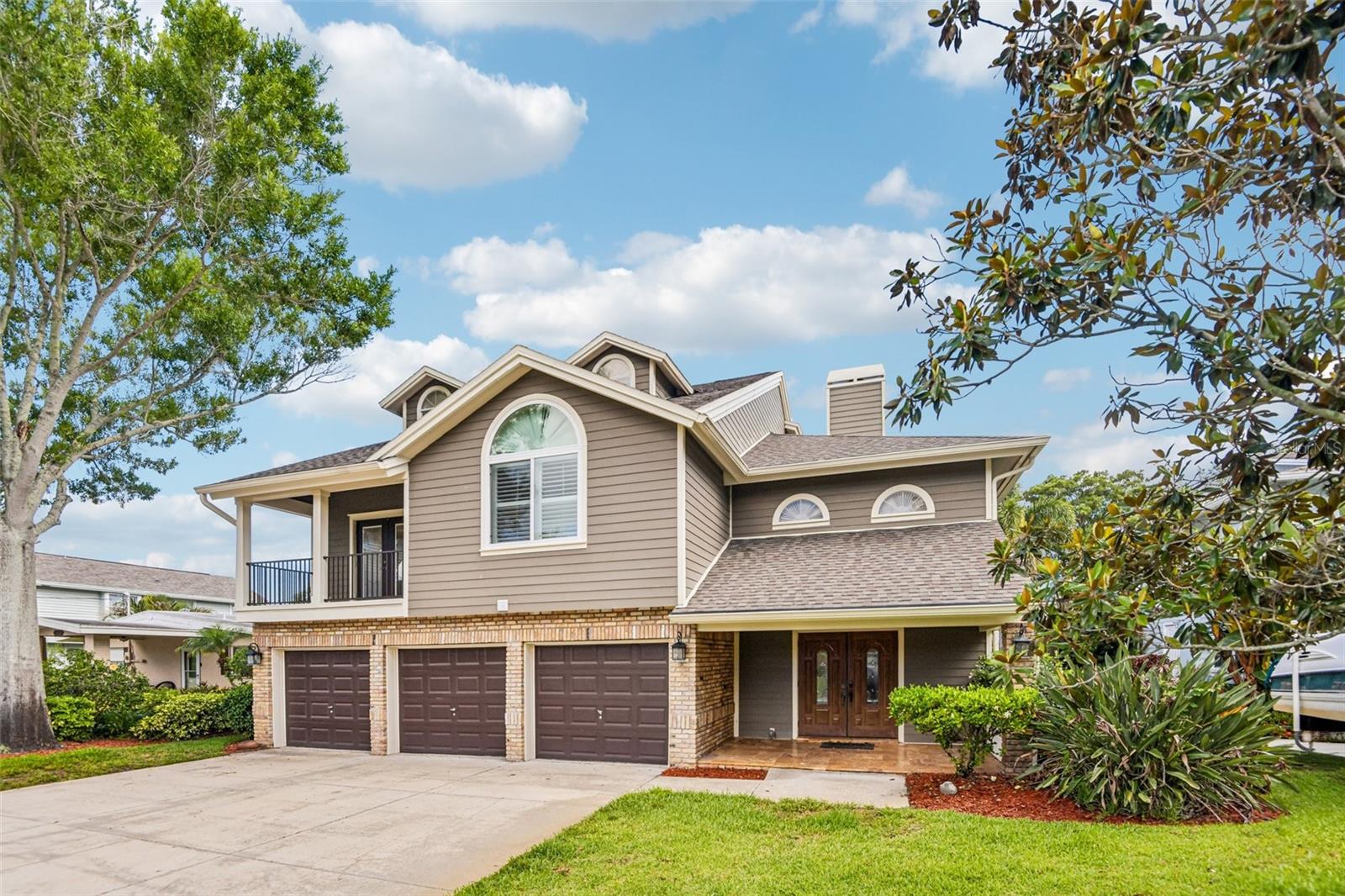 Discover this beautifully updated waterfront canal home offering direct access to Lake Tarpon and an exceptional blend of luxury, functionality, and long-term durability. This spacious 5-bedroom, 3.5-bath, 4,496 sq ft residence features a rare first-floor mother-in-law suite with a private close-off pocket door option, ideal for guests, multigenerational living, or extended stays.

A standout feature is the oversized 3-car garage, complete with a built-in 10×10 storage room and extensive built-in shelving, providing unmatched storage and organization.

The home has undergone major capital improvements in recent years, making it truly move-in ready. A new roof was installed in April 2021, followed by three new HVAC systems replaced in May 2023 for optimal comfort and efficiency. In October 2019, the entire exterior was upgraded with Hardie-Board color plus siding installed over full house wrap, eliminating the need for ongoing painting and offering superior moisture and pest resistance. That same year, all windows and pool-deck sliding doors were replaced (October 2019), enhancing hurricane resilience, energy efficiency, and insurance savings.

Outdoor living shines with a large screened pool enclosure and a fully refurbished private dock completed in September 2023, featuring davits, covered lifts, and direct canal access for boating enthusiasts. Inside, the home boasts two full kitchens, two laundry rooms, a dramatic three-story foyer, and premium finishes throughout.

For buyers seeking a turn-key experience, the property can be purchased fully furnished, offering a seamless transition into one of Palm Harbor’s most desirable waterfront lifestyles. NOTE- NO HOA FEES, NO DEED RESTRICTIONS, NO FLOOD INSURANCE- SEE LOMA ATTACHED.

“Includes full 360° virtual tour and walkable video for remote buyers.” SEE ATTACHMENTS AND VIDEO TOUR LINKS- INCLUDES FLOOR PLAN LAYOUT INTERFACE WITH 360 VIDEO WALK THRU