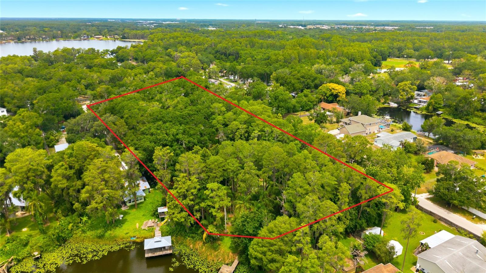 4.14 ACRES - LAKE VIEWS - BUILDER OPPORTUNITY - PRIVATE ESTATE POTENTIAL ___ Rare opportunity to own 4.14 acres in the heart of Odessa with beautiful views of Lake Seminole, offering exceptional potential for a builder, developer, or someone looking to create a private custom estate. Nestled within one of Odessa's most sought-after acreage corridors, this property combines privacy, natural beauty, and convenience in an increasingly rare setting.
___
For builders and developers, the property offers the opportunity to create a boutique luxury enclave with conceptual lot layouts already envisioned. For those dreaming of a custom home, imagine expansive outdoor living, a resort-style pool, guest house, detached garage, workshop, and space for recreational vehicles or boats—all overlooking the peaceful lake.
___
Odessa remains one of the Tampa Bay area's premier luxury communities, known for estate homes, scenic beauty, and spacious acreage while remaining just minutes from modern conveniences. Located less than 10 minutes from the Suncoast Parkway, you'll enjoy convenient access to Tampa International Airport, Downtown Tampa, premier shopping, dining, and entertainment.
___
Existing well, septic, and electric service are already in place, providing added value for future improvements or new construction. Buyer to verify zoning, land use, subdivision potential, development opportunities, and intended use with Pasco County.
___
Builder/Developer package available upon request, including conceptual lot layouts, renderings, market analysis, and development insights. Contact Jill Ross or Stephanie Hessling for additional information. *Virtually AI Conceptual Images*