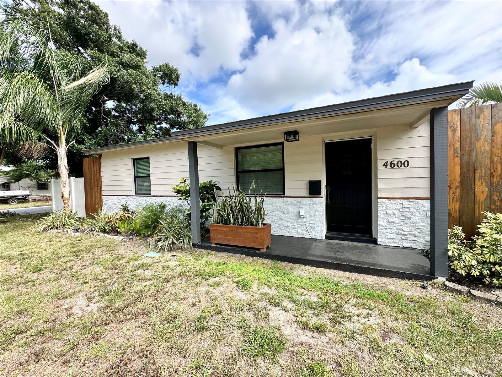 Short Sale. Don’t miss this unique opportunity to own a well-maintained 1951 solid block home situated on a spacious corner lot with incredible potential for expansion. The oversized outdoor living space is a true Florida oasis, featuring a relaxing Jacuzzi hot tub, a tranquil waterfall pond, mature palm trees, flowering tropical plants, staghorn ferns, an avocado tree, and a moringa tree. With ample room for a pool, garden, or  gazebo, the possibilities are endless.


Step inside and be welcomed by beautiful original hardwood floors that flow throughout the living room, hallway, and bedrooms, preserving the home’s timeless character and charm. The fully renovated bathroom features updated plumbing, electrical, flooring, lighting, and fixtures, providing modern comfort while complementing the home’s classic appeal.


The family room boasts attractive new luxury vinyl plank flooring, creating a warm and inviting gathering space. The adjacent laundry room has been completely updated with new cabinetry, drywall, electrical upgrades, and includes a modern Rain Bird irrigation timer and sprinkler system supplied with well water.  The main roof was done in 2018, and the new flat roof was just done in 2026.


One of the standout features of this home is the approximately 300-square-foot screened lanai, fully re-screened in 2024 and enhanced with waterproof flooring. A stunning 92-inch sliding glass door opens to the backyard retreat, creating seamless indoor-outdoor living and providing the perfect space for entertaining, relaxing, or enjoying Florida’s beautiful weather year-round.


This move-in-ready home offers character, updates, and exceptional outdoor living. Schedule your showing today and discover everything this special property has to offer.