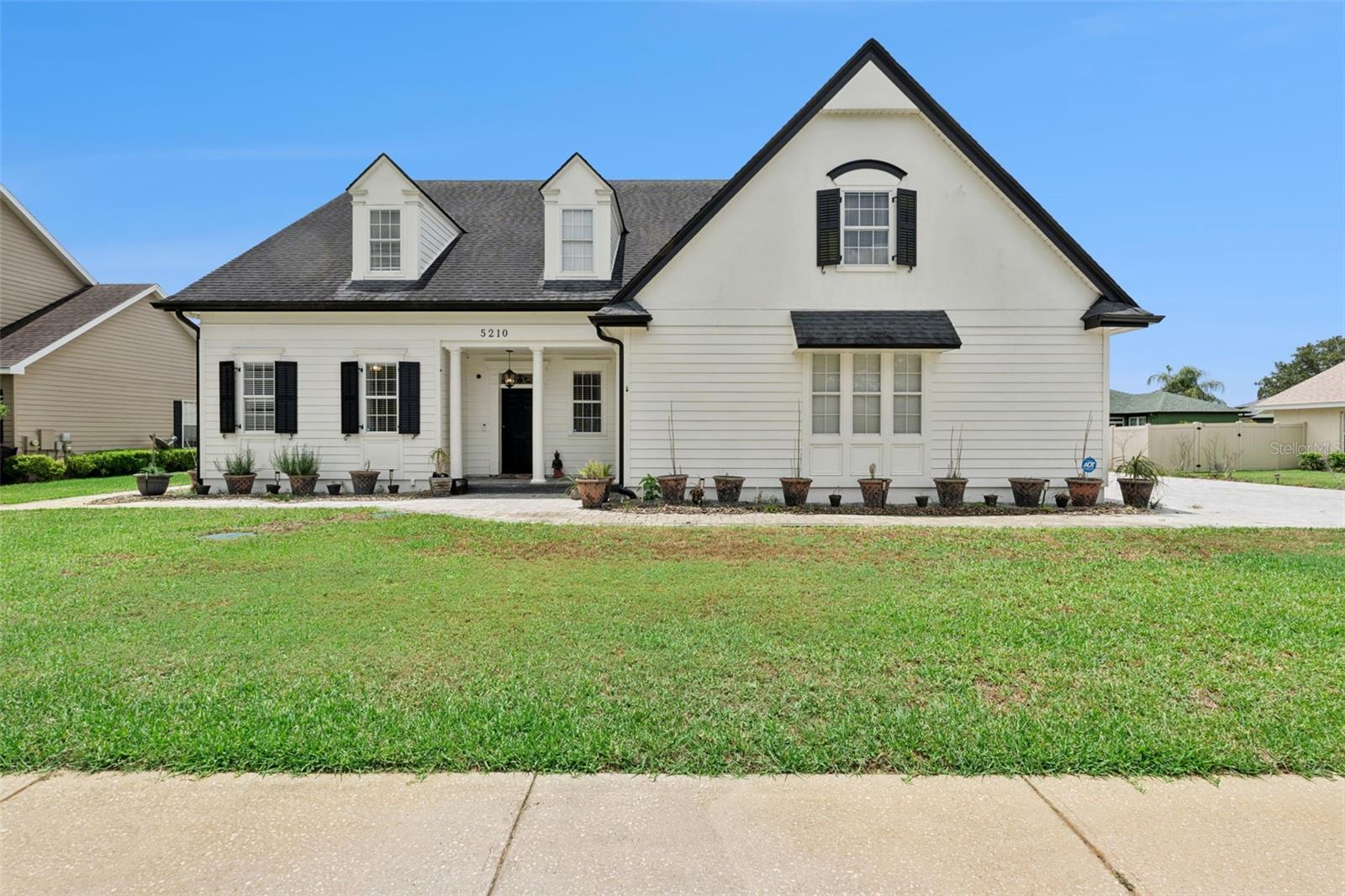 **This house comes with a REDUCED RATE through the seller's preferred lender. This is a lender-paid rate buydown that reduces the buyer's interest rate and monthly payment.**

Welcome to 5210 Hammock Circle in St. Cloud, a spacious two-story home offering 4 bedrooms, 3.5 bathrooms, a versatile loft, and multiple indoor and outdoor living spaces designed for comfort and flexibility. With a functional layout, generous living areas, and exceptional parking space, this home offers the perfect balance of everyday living and entertaining.

Inside, the main living areas flow seamlessly between the kitchen, dining, and gathering spaces, creating an inviting atmosphere that feels open, connected, and ideal for hosting. The flexible floor plan offers endless possibilities for a home office, guest space, hobby area, or additional living needs, while the upstairs loft serves as the perfect bonus space for a media room, playroom, study area, or second lounge.

One of the home’s standout features is the oversized driveway with parking for up to 12 vehicles, a rare and highly desirable feature that offers incredible convenience for larger households and entertaining guests.

Outdoor living is equally inviting with a welcoming front porch, covered rear porch, and extended patio area ideal for grilling, outdoor dining, relaxing, or enjoying the Florida lifestyle year-round. The backyard provides plenty of open, usable space to create your own private outdoor retreat.

Located just minutes from Lake Nona, this home offers convenient access to one of Central Florida’s fastest-growing destinations, known for its Medical City, highly rated dining, shopping, entertainment, and major employers. Residents also enjoy easy access to nearby parks, lakes, schools, and major roadways connecting to Kissimmee, Orlando, and surrounding Central Florida areas, all while enjoying the comfort of a residential neighborhood setting.