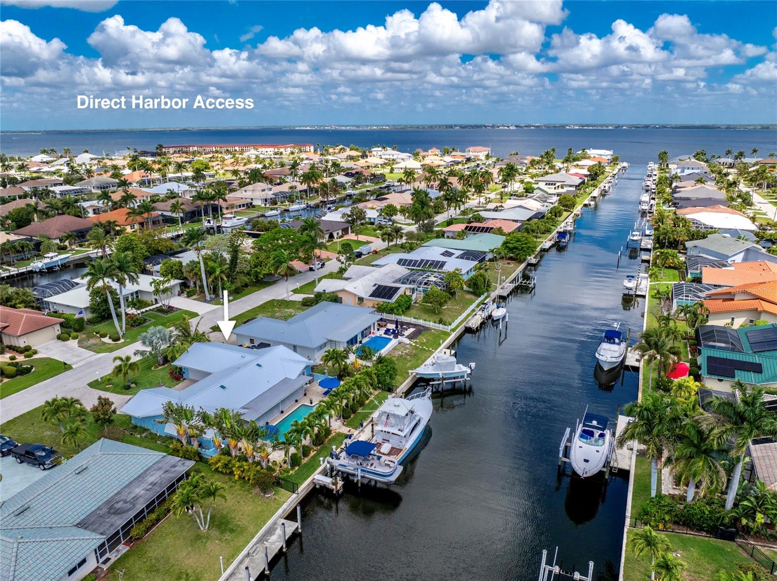 MID-CENTURY MODERN WATERFRONT TRIFECTA. DEEP DRAFT WATER. 5 MINUTES - DIRECT HARBOR ACCESS. 80 FT WATERFRONT. 46 FT DOCK 8 FT FINGER DOCK-10K LIFT.  Along Florida's coastline, a hidden gem awaits those seeking an exceptional residence matched by an exceptional boating lifestyle. But what makes this waterfront home stand out above the rest? Nestled in the highly coveted deep draft sailboat section of Punta Gorda Isles, this METICULOUS REDESIGN seamlessly blends timeless architecture with $500K in LUXURY UPGRADES. A CHEF-EQUIPPED KITCHEN featuring a complete suite of 2023-2025 PROFESSIONAL-GRADE APPLIANCES includes a BOSCH FRENCH DOOR REFRIGERATOR - BEVERAGE DRAWER, DUAL VIKING 30" WALL OVENS, MICROWAVE, VIKING CERAMIC GLASS COOKTOP for simultaneous cooking perfection with restaurant-quality results, and whisper-quiet BOSCH DISHWASHER. CUSTOM WALL-TO-WALL CABINETRY anchors the kitchen with storage for every entertaining essential, an EXPANSIVE MITERED GLASS WINDOW REVEALS the tropical lanai beyond, all under the warm glow of Bruck pendant lighting and skylight. SWEEPING GRANITE COUNTERS provide endless space for elaborate spreads, charcuterie boards, and the fresh catch of the day. AT THE CENTER, A 10-FOOT ISLAND WITH STORAGE ON ALL SIDES BECOMES THE NATURAL GATHERING PLACE WHERE GUESTS LEAN IN WITH WINE GLASSES IN HAND - A HOME THAT FEELS AS WELCOMING AS IT IS IMPRESSIVE. But the entertainment doesn't stop there. The fourth bedroom has been masterfully converted into a CUSTOM NAUTICAL BAR. Reclaimed nautical lighting casts a perfect glow against the wood-paneled ceiling, and photographs of legendary anglers with their prized catches line the walls—a tribute to the fishing heritage of these waters. Beyond the exquisite interior lies your private tropical retreat—a RESORT-STYLE POOL framed by CHRISTMAS AND MAJESTIC TRAVELER PALMS. This poolside retreat offers complete seclusion and serenity, transforming every day into a getaway, surrounded by YOUR PERSONAL PALM-STUDDED SANCTUARY. Citrus blossoms perfume the air, and ripe fruit hangs from your own collection of mature tropical trees. Meyer lemons and key limes for the sundowners. Blue and Mahoi Bananas, tangelo, tangerine, mangos, and peaches dot the grounds. A true taste of the tropics, just steps from your door. ISN'T IT TIME YOU ANCHOR HOME TO 80 SABAL DRIVE - WHERE EVERY DAY IS A FIVE-STAR ESCAPE AND LIFE IS AS EASY AS A GULF BREEZE. YOU FEEL IT THE MOMENT YOU STEP ONTO THE DOCK. YOU FEEL IT AGAIN WHEN YOU WALK INSIDE. THIS HOME HAS BOTH, AND ONCE YOU'VE EXPERIENCED IT, NOTHING ELSE QUITE MEASURES UP. ADDITIONAL PREMIUM FEATURES: | 2 Shore Power Pedestals with water and 50 amp electric | Water Manifold | Standing Seam Aluminum Powder Coated Metal Roof | 2025 Impact Sliding Glass Windows and Doors | Porcelain Tile Floor | 2025 Solid Wood Kitchen Cabinetry |Bruck Pendant Lights -Hallway Sconces | Hurricane-Proof Skylights | Impact French Door and Front Doors | Solid Wood Interior Doors and Trim | Bamboo Bathroom Vanities - Quartz Counters | Whole House Water Softener | R.O. Water Filtration | 2025 AC - UV Light | Master Bedroom Mini Split | 2021 Garage Door, equipped with Mini Split A/C | Epoxy Garage Floor | 2019 Paver Driveway | 2025 Variable Pool Pump - Heater - Chiller System | 2019 Electric Panel | Bahama Shutters | Pro-Vista Heat Tolerant St. Augustine Blend Chinch bug - Weed Resistant | 2021 Irrigation System | 2021 Aluminum Fencing | 2025 Exterior - Interior Paint | 2024 Gutters