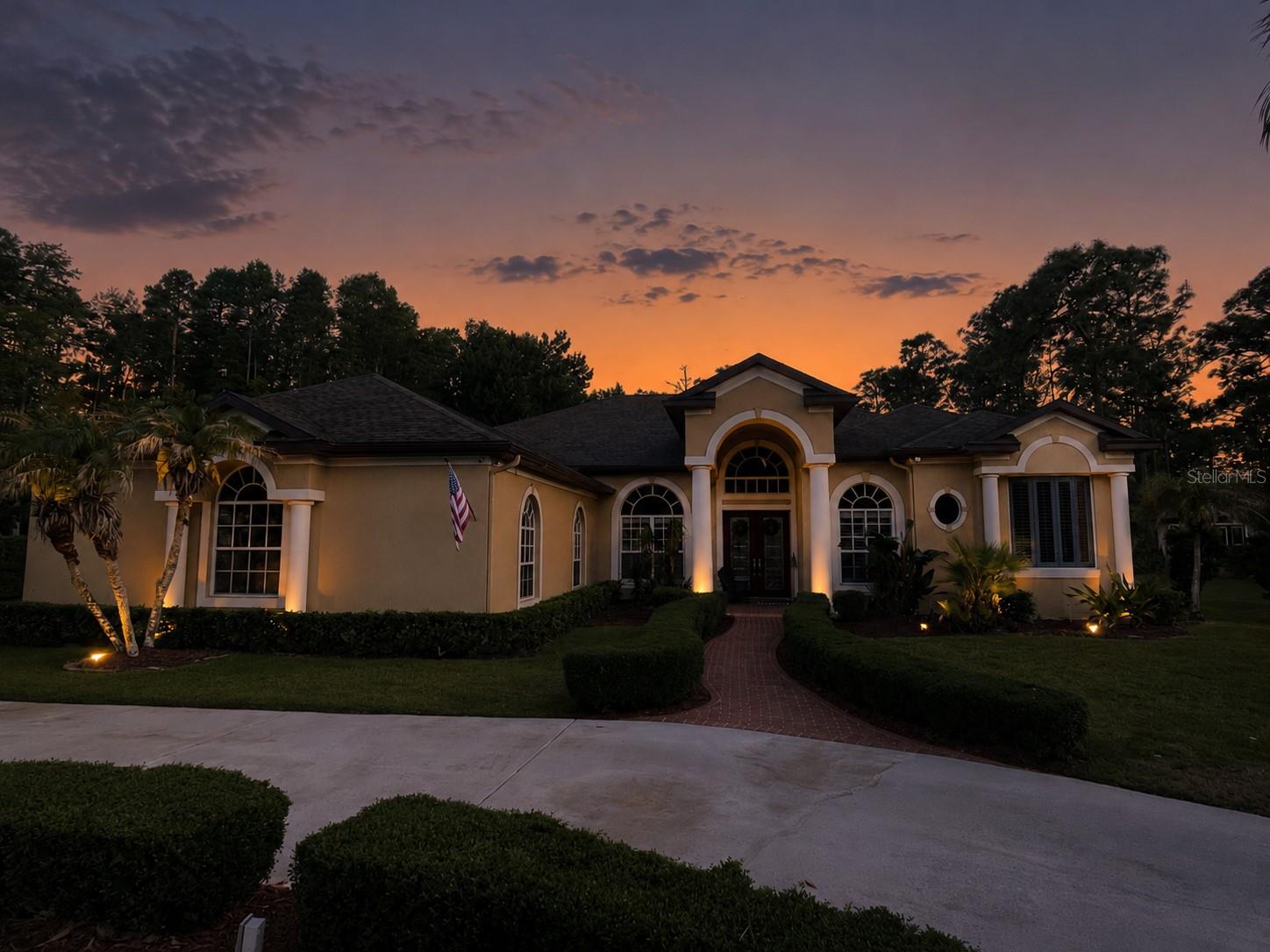 Discover the hidden gem of Aristida, one of the Trinity area’s most exclusive communities, where this custom-designed home shines as one of its finest residences. Right at the end of a serene cul-de-sac, this expansive lot offers privacy without isolation, blending natural surroundings with neighborhood charm. Architect-designed and custom-built, the home showcases clean lines, lofty ceilings, and abundant natural light, (perhaps the brightest home in the community) with oversized windows that bring the outdoors in from every room. The main living spaces feature travertine floors, soaring 12-14’ ceilings, crown molding, enhanced baseboards, and elegant tray ceilings in both the primary suite and formal dining room—creating an ambiance that’s sophisticated yet inviting. Entering through the front door, you’re immediately drawn in by the thoughtfully curated details. The formal dining room, defined by classic columns, flows seamlessly into the main areas. The great room, formal living/dining, and primary suite, each lead out to the screened lanai. Outside, a pavered deck surrounds the saltwater pool with a tranquil waterfall, perfect for relaxing or entertaining. The gourmet kitchen boasts solid cherry cabinets with pull-out drawers, granite countertops, and stainless steel appliances, offering both style and functionality. Pocket sliders in the great room fully open up the home, merging indoor and outdoor spaces for true Florida living, with a surround sound system enhancing every movie night. The expansive primary suite includes a sitting area, dual walk-in closets, and a luxurious en-suite bath with an oversized jet tub and a dual-head shower. Additional bedrooms offer generous space, 10’ ceilings, and tall doors, while a flexible front room can serve as an office, den, or extra lounge. Two tank-less water heaters provide quick hot water anywhere in the home. Pool Heater, plantation shutters installed in 2018 and microwave upgraded to convection. Dishwasher, upgraded water softener, MAIN HVAC (5 ton), Fire pit area 2019. Exterior paint 2020. ROOF, exterior security cameras with DVR/app access, fireplace converted to propane w/removable tank, radiant barrier insulation added to garage doors and part of attic 2021. Stove/oven 2022, and full house charcoal filtration system 8/2024. Primary suite HVAC rebuilt in 2017, capacitor replaced and serviced 9/24, maintained regularly. POOL AREA: Pool refinished, pavers re-sanded and resealed and all birdcage screens replaced in winter of 2025, salt cell replaced in October. Landscape lighting and updated lighting by garage, smart garage doors and Ecobee smart thermostats, lanai speaker system, stove/oven all replaced in 2022. Soft start recently added to the main HVAC unit as an added bonus. The oversized three-car garage is ideal for car enthusiasts, and the expansive driveway makes parking a breeze. Located in Zone X, outside of flood and evacuation areas, this property also remained untouched by storms over the years. With all the amenities of a private retreat, this is a home that truly stands out—don’t miss the opportunity to make it yours. *Please note that there is no sign in front of the home, as the county is preparing to do easement work before the roads will be repaved (no assessment!) in the fall.