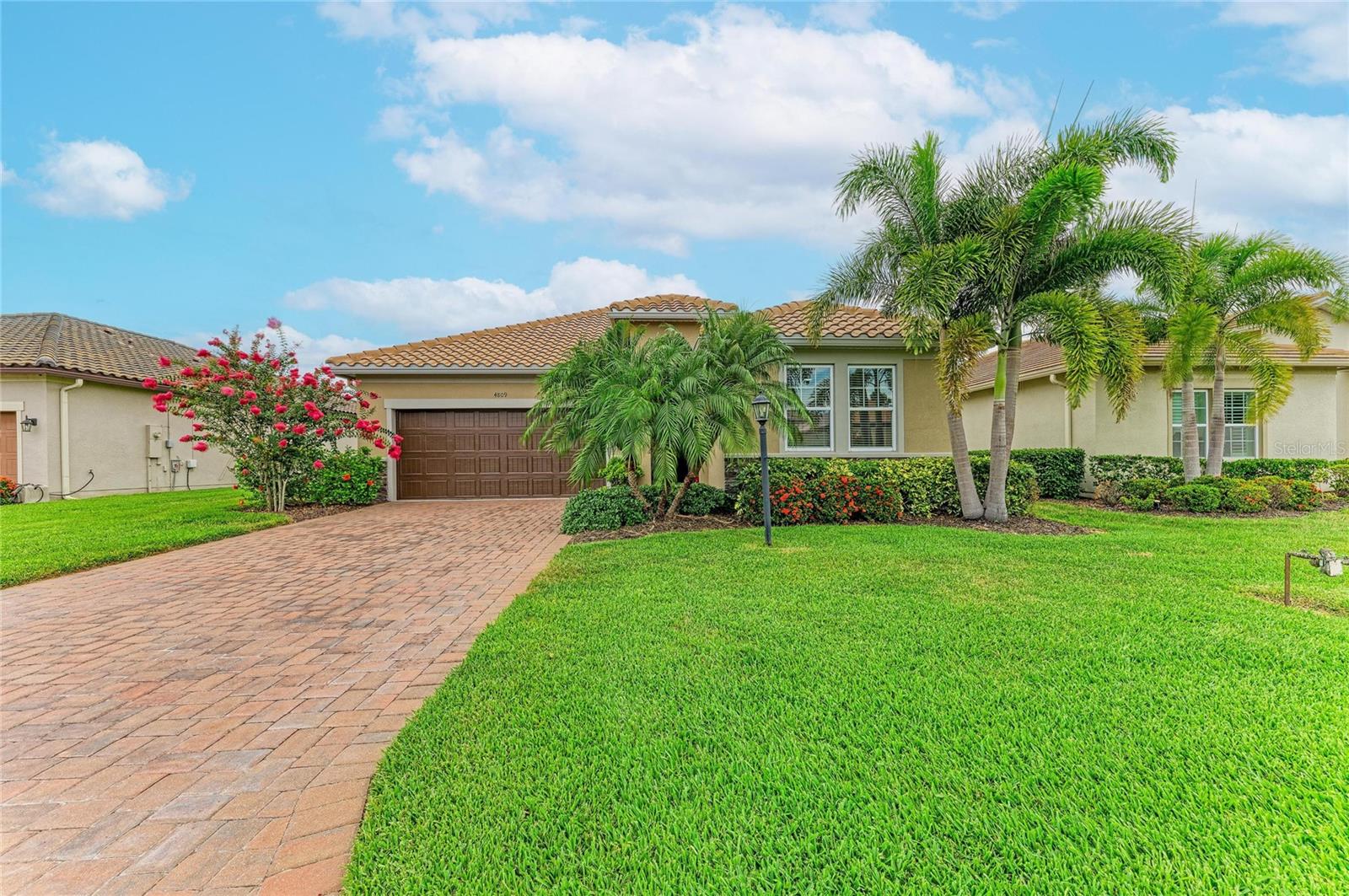 Meticulously maintained and beautifully updated, this move-in ready Ashton Woods Lazio model offers the perfect combination of comfort, convenience, and low-maintenance Florida living. Located in the maintenance-free section of Rosedale Golf & Country Club, residents enjoy lawn care, cable TV, and high-speed internet included, along with the added benefit of NO CDD fees, making this home an exceptional value in one of Lakewood Ranch's most sought-after gated communities.  Featuring 3 bedrooms, 2 bathrooms, and nearly 1,700 square feet of thoughtfully designed living space, the bright open floor plan is ideal for both everyday living and entertaining. Fresh coastal-inspired paint, updated lighting, new ceiling fans, and luxury vinyl plank flooring throughout all bedrooms create a light and inviting atmosphere, while tile flooring throughout the main living areas means there is no carpet anywhere in the home.

The kitchen serves as the centerpiece of the home with quartz countertops, a large island, 42-inch shaker-style cabinetry, designer backsplash, stainless steel appliances, gas range, and plenty of space to gather with family and friends. The spacious primary suite features a tray ceiling, walk-in closet, and refreshed ensuite bath, while two additional bedrooms provide flexibility for guests, a home office, or hobbies. One of the home's most exciting features is the opportunity to create your own custom outdoor retreat. The covered lanai enjoys private landscaped views with a peek of the water and is already pre-plumbed and wired for an outdoor kitchen. The home is also pre-wired for a future pool and spa, giving the next owner a head start on transforming the backyard into the Florida oasis they've been dreaming about. Additional features include hurricane screens for all windows, an impact glass front window, tankless water heater, irrigation system, in-wall pest control system with ongoing quarterly service, semi-annual HVAC maintenance, and washer and dryer included. Life in Rosedale is about more than just the home. Residents enjoy a staffed gatehouse entrance, Junior Olympic heated pool, fitness center, tennis courts, clubhouse, restaurant and bar, dog parks, golf cart-friendly streets, and optional golf memberships. Surrounded by mature landscaping, scenic lakes, and beautifully maintained grounds, Rosedale offers a resort-style lifestyle just minutes from Lakewood Ranch's shopping, dining, entertainment, and the Gulf Coast's world-famous beaches. This meticulously maintained home offers the ideal combination of comfort, convenience, and resort-style living. Schedule your private showing today.