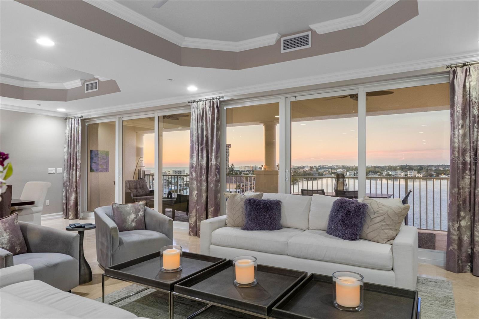The crown jewel of Redington Shores, executive penthouse residence 702 in Redington Shores Yacht & Tennis Club. This exceptional 3,990-square-foot under-air residence is one of the largest and most extensively updated units in the community, offering 4 bedrooms, 3.5 baths, plus a waterfront 10 X 20 Ft office / artist studio with a closet. A 60 Ft waterfront terrace spans all living areas, art studio & primary Bedroom suite, showcasing Gulf & Intracoastal Waterway views. Executive PH 702 conveys with a private poolside cabana & 3 rare covered parking spaces ( 1 under the building and 2 covered near lobby). Enjoy the spacious feel of a single-family home with the security of a managed, 24-hour gated & guarded condominium. A 28 Ft Grand Foyer with 10'  tray ceilings, skylight, art alcoves and 24-inch travertine marble flooring with Black Galaxy granite inlays leads to the 1,250 Sq Ft great room featuring a 30-foot wall of high-impact glass. That’s when it hits you, I’m at the beach in an executive penthouse, it’s beautiful. The open-concept great room layout includes a waterfront dining area, living area with redesigned 7'  built-in wet bar, wine chiller and skylight. A spacious 20' x 21' Ft gourmet kitchen with more than ample cabinetry, tumbled marble backsplash, 36-inch Sub-Zero refrigerator, an 18-inch custom Sub-Zero wine column and a 36-inch Sub-Zero freezer. New Bosch dishwasher, newer induction cooktop, large 4-by-7-foot center island and walk-in pantry. Over $6,000 in additional lighting, solid-core parlor doors, and 1,600-plus linear feet of custom molding enhance the home. Flooring is primarily travertine with exquisite design elements and Brazilian Redwood. Three of the larger bedrooms feature en-suite baths. There is also a half bath in the center hallway, ensuring overnight guests are comfortable. The waterfront primary/main suite offers extra-large custom dual closets, Jacuzzi soaking tub, privacy room, bidet, oversized walk-in dual-head shower, extended 15-foot dual vanities and porcelain tile flooring with granite accents. Additional features include a laundry room, dual-zone HVAC systems with REME Halo air purifier and a Nuevo whole-house water system. Refer to floor plan for room sizes and layout. Amenities include a Las Flores building private heated pool and spa. Community amenities include Tennis & pickleball courts, Clubhouse with new fitness center, heated community pool & spa, dog-walking areas and 24/7 gated guarded security.  While The complex offers a scenic waterfront boardwalk with a dedicated kayak launch, The Beach is just steps away. There are boat slips available for sale or lease and Yes, we can locate you one. Enjoy spectacular long-range water views and glowing sunsets from the 60 Ft expansive terrace, where dolphins, manatees and passing watercraft create a remarkable Florida coastal lifestyle. The ever-changing sunset/nighttime skyline views are amazing. Redington Shores is a small, intimate beach community with underground utilities for safety & aesthetics, police department & renowned restaurants, and is accessible and bikeable. Note: A similar penthouse of size and caliber right across the street would easily cost from $3.5 to $4 million  and that's without the 24 /7 gated security, tennis, clubhouse, boat slips and waterfront amenities that the 24-acre private RSY & tennis club provides. Live a fantastic life by the sea. Please enjoy the two tours. Showings are private & with appointments only.