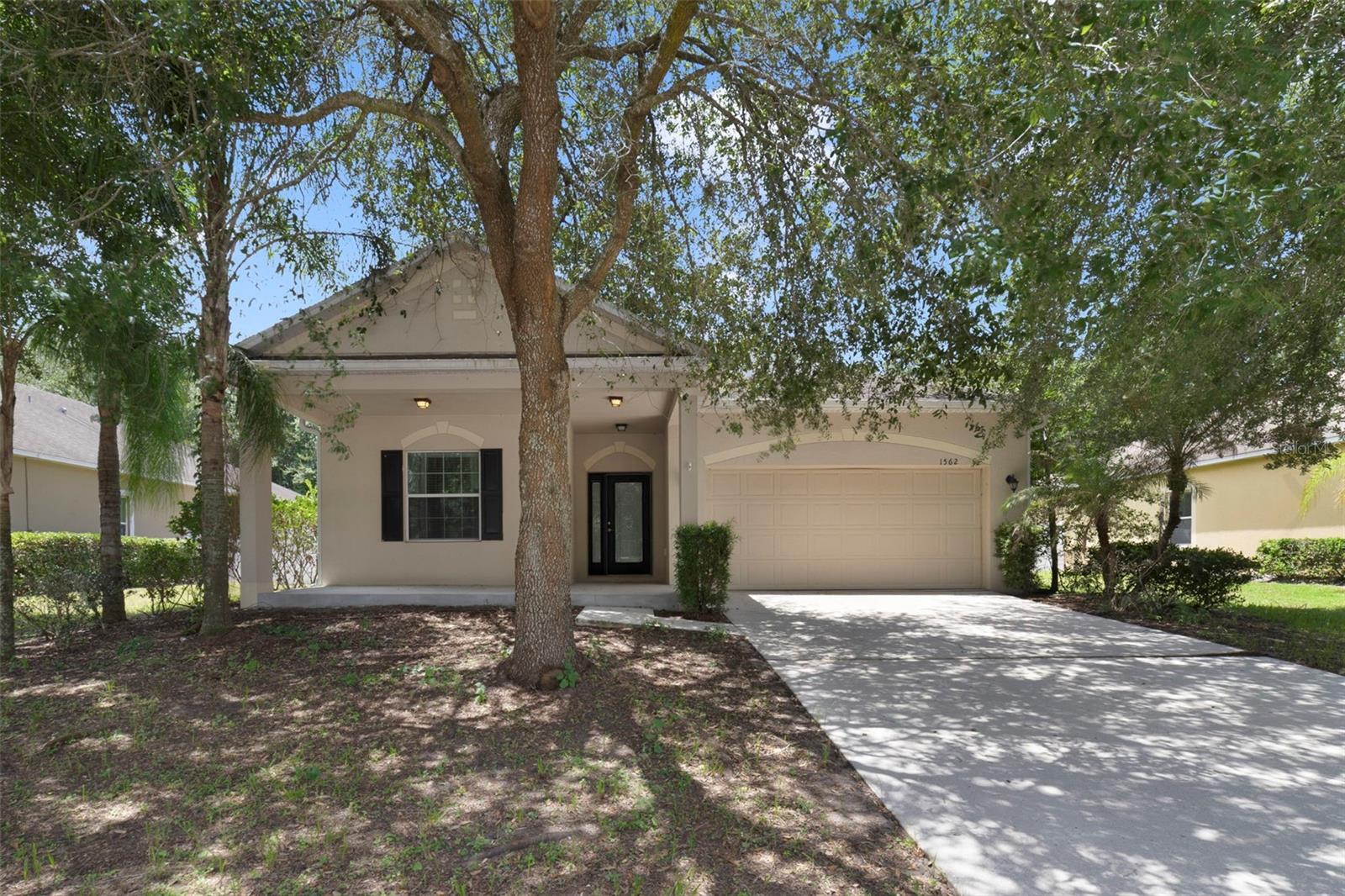 Virtually Staged. Welcome home to this MOVE-IN READY 3-bedroom, 2-bath residence nestled in the quiet, established community of Lake Pleasant Cove in Apopka. Framed by MATURE SHADE TREES that enhance its curb appeal, this inviting single-story home offers comfortable living, a FUNCTIONAL FLOOR PLAN, and a spacious backyard perfect for enjoying the Florida lifestyle. Step through the ELEGANT ETCHED GLASS FRONT DOOR into a bright and welcoming Living Room, where LUXURY VINYL PLANK FLOORING and abundant natural light create a warm, inviting atmosphere. The open layout flows seamlessly into the SPACIOUS KITCHEN, making everyday living and entertaining effortless. The Kitchen is thoughtfully designed with an abundance of cabinetry and counter space, a stylish tile backsplash, BREAKFAST BAR, and a convenient closet pantry. An adjoining EAT-IN DINING AREA provides the perfect spot for casual meals while overlooking the backyard. Just off the Kitchen, the convenient Laundry Room includes the washer and dryer, and a shelf to store supplies. Sliding glass doors from the dining space lead to an ENCLOSED, SCREENED REAR PORCH—an ideal place to enjoy your morning coffee, unwind in the evenings, or entertain guests while overlooking the large fenced backyard with plenty of room for pets, play, gardening, or future outdoor enhancements. All three bedrooms feature LUXURY VINYL PLANK FLOORING, offering both style and easy maintenance. The spacious Primary Suite serves as a relaxing retreat with a walk-in closet and a private EN SUITE BATH complete with dual sinks, a GARDEN TUB, and a separate step-in shower. IDEALLY LOCATED, this home is just minutes from Wekiwa Springs State Park, where you can enjoy kayaking, hiking, swimming, and Florida's natural beauty. Nearby LAKE APOPKA WILDLIFE DRIVE offers scenic wildlife viewing and biking, while shopping, dining, and entertainment are easily found at APOPKA CITY CENTER and along State Road 436. You'll also appreciate CONVENIENT ACCESS to major roadways, making commuting to Orlando, Downtown Winter Garden, and Central Florida's WORLD-FAMOUS ATTRACTIONS quick and convenient. Combining move-in-ready condition, a peaceful neighborhood setting, and an OUTSTANDING LOCATION close to parks, shopping, and recreation, this Lake Pleasant Cove home is ready to welcome its next owners. Make this one yours before it's gone!