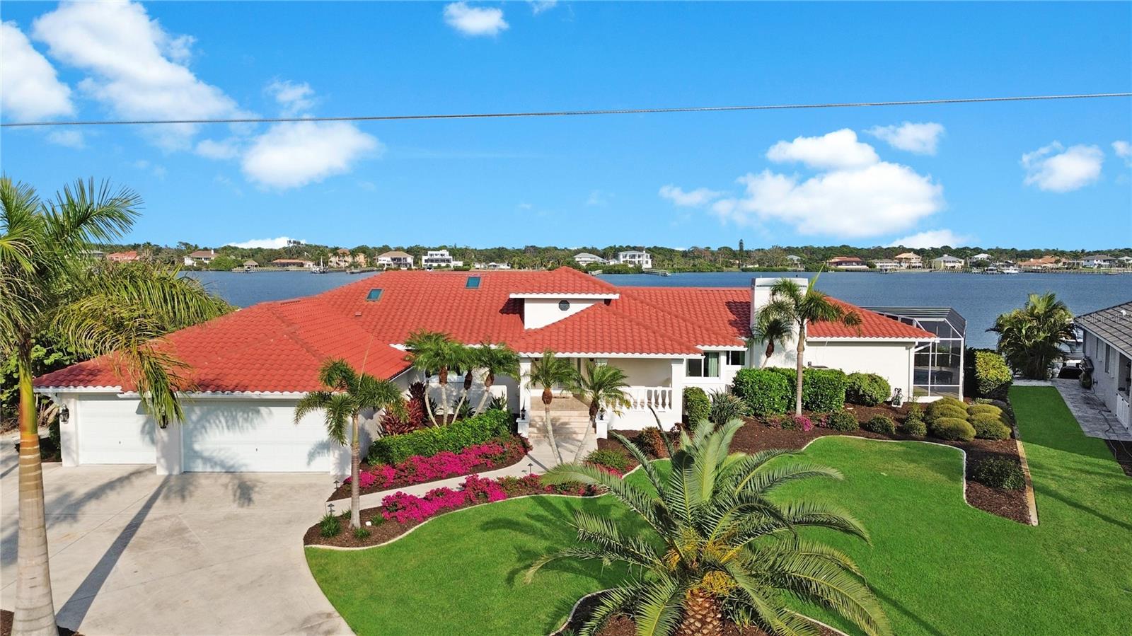 Welcome to 8115 Manasota Key Road — a breathtaking waterfront estate perfectly positioned on Lemon Bay with the Gulf beaches just steps away. This home offers a truly unmatched lifestyle: peaceful sunrise views over the water, sunset strolls on the sand, and effortless access to boating, dining, and everything Manasota Key is known for!

From the moment you walk in, the grand foyer sets the tone. Soaring ceilings draw your eyes up, and the stunning wood-burning fireplace anchors the spacious living area, giving the home a warm, inviting, and elegant feel. The open layout flows right into the heart of the home. A beautifully designed kitchen with generous counter space, custom cabinetry, and a layout perfect for both everyday living. 

Nearly every room captures wide, calming water views filling the home with natural light. Theres 5 bedrooms, including two private en-suites, plus two guest bedrooms, a large office, a formal dining room, and a cozy breakfast nook, there is plenty of room for hosting guests or creating your ideal work-from-home setup.

The indoor-outdoor connection is exceptional. Step outside to your newly resurfaced pool and private screened-in lanai — the perfect spot to unwind, entertain, and watch the colors of the bay shift throughout the day. Whether you're spotting dolphins, fishing from your dock, or relaxing poolside, every day feels like you’re living on vacation.

The property also features a 156-foot concrete seawall and private dock, offering direct access to the Intracoastal Waterway, Stump Pass, and the Gulf of Mexico. Recent upgrades include wide-plank flooring, hurricane-rated windows and doors, fresh interior and exterior paint, a 2022 concrete tile roof, and professional landscaping by Hazeltine. An oversized three-car garage and spacious circular drive round out the home’s impressive features.

Whether you’re searching for a private coastal retreat or a stunning home built for entertaining, 8115 Manasota Key Road delivers it all. Schedule your private showing today and experience the very best of waterfront living.