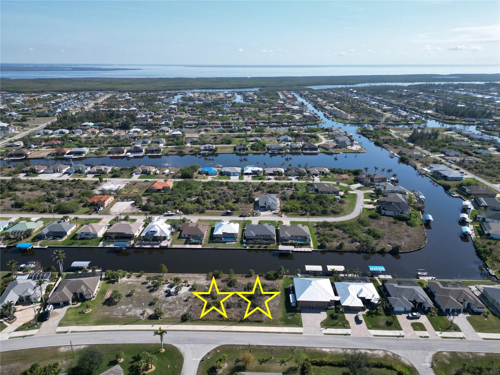 Double Lot For Sale with 160 feet of concrete seawall making this a Boaters Dream not the mention it's only one bridge out to the Charlotte Harbor and the Gulf of Mexico.  The property is 160 x 125, so being roughly 1/2 acre gives you plenty of space to place your home on the property. This gives you the ability to build a larger home & pool or possibly a detached structure for your toys.  Water, Sewer and Electric are all run to the property and ready for hook up making building a breeze. The community has an optional HOA that is only $120 annually. The community offers multiple parks, playground, sidewalks, public boat ramp and over 50 miles of navigable waterways for your boating enjoyment. The property is 20 minutes to the beaches on Boca Grande Island or Manasota Key, 15 minutes to shopping / dining and 10 minutes to over six semi-private golf courses. Double lots with a seawall are very hard to find, so don't let this one get away.  Secure Your Piece of Paradise Today...