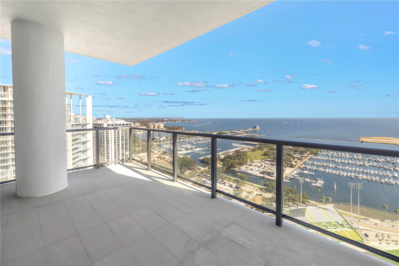 Experience the epitome of luxury living at Saltaire on the 30th floor in downtown St. Petersburg. Revel in the awe-inspiring panoramic views that grace this completely new 3-bedroom, 4-bathroom end unit condominium. Saltaire 3003, a distinguished Azure North residence, offers an abundance of space and uninterrupted vistas, stretching from Tampa to the St. Petersburg Pier, across the open Bay, all the way to the Sunshine Skyway.  Take pleasure in the breathtaking sunrises and the delightful sight of boats skimming across Tampa Bay from your expansive east and north-facing terrace, ideal for both relaxation and alfresco dining. This condo is adorned with opulent finishes, featuring 24" x 48" matte-finish porcelain tiles throughout. The kitchen, bathrooms, and laundry room are appointed with contemporary-European style cabinetry in high-gloss white and coastal woodgrain, boasting soft-close doors and ample storage. Exquisite quartz countertops grace the kitchen, with a eye-catching waterfall edge bar top. The kitchen is equipped with top-of-the-line Jenn-Aire appliances and has an upgraded extended pantry. The living room dry bar, complete with an undercounter wine fridge, is perfect for hosting cocktail parties. Frameless Euro-style glass doors adorn all the showers, and additional floor outlets in the living area provide convenience for furniture and lighting placement. The unit is prepped for effortless installation of motorized blinds and window treatments.  Saltaire ensures comfort with two zoned air handlers for air conditioning, while cooling towers and hot water are shared among the building's residents, with the cost included in the HOA fees. This unit offers two parking spaces and a convenient closet storage just outside your front door.   Saltaire pampers its residents with a host of amenities, such as optional valet parking, a dedicated front desk staff, and on-site property management. The expansive pool deck features sun shelf loungers, multiple outdoor kitchen areas, and cabanas with striking waterfront views. Stay active in the well-equipped fitness area and workout studio, unwind in the news café, spend time with your furry friend at the 7th-floor dog park, and entertain in the stylish club room.  Nestled in the heart of downtown St. Pete, Saltaire is a stone's throw away from the iconic St. Pete Pier, an array of attractions, music venues, museums, world-class restaurants, and shopping. Across the street, you'll find Al Lang Stadium, the home of the Tampa Bay Rowdies soccer team, or simply savor the game from your own private balcony.  Don't miss the opportunity to be part of this new pinnacle of luxury living in downtown St. Petersburg. Schedule your exclusive private tour today and be captivated by the splendor of Saltaire!