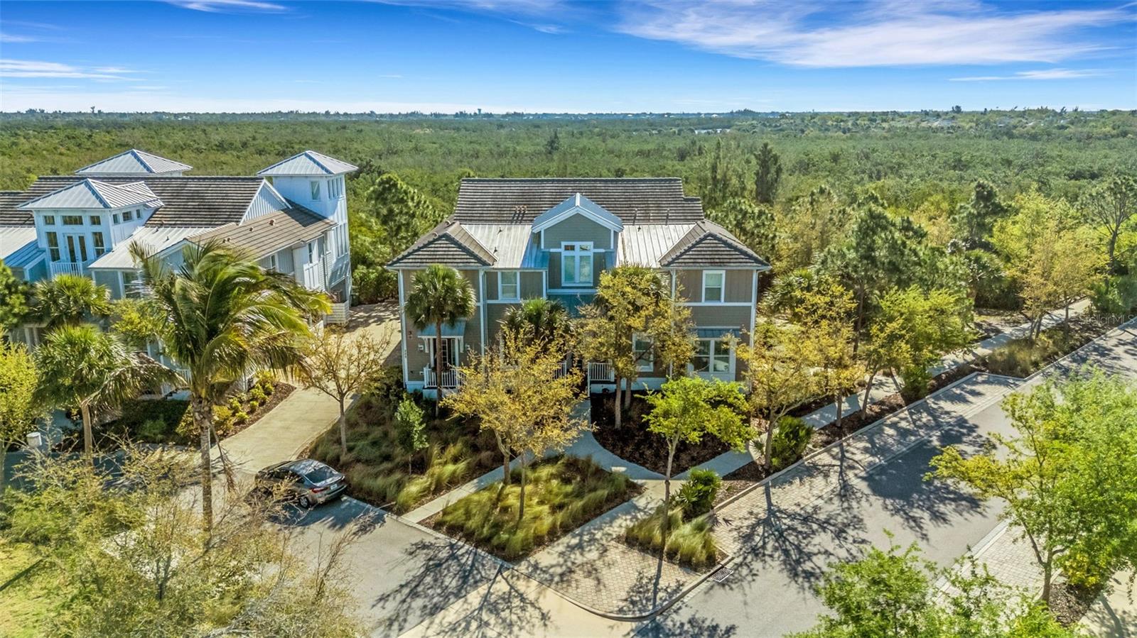 Have it all within minutes of Anna Maria Island. Located just beyond the gates of highly desirable Harbour Isles! This spectacular coastal luxury residence boasts over 2,000 square feet of spacious, meticulously maintained living area. Featuring three-bedrooms, two-bathrooms, a versatile open retreat, an oversized two-car garage, and a private screened lanai, this home has been gently used as a second-home beach getaway and shows exactly like a model!  Built to the highest standards, this home features Green LEED certification, durable concrete block construction, and PGT impact windows for total peace of mind and maximum energy efficiency. Inside, you are greeted by a tastefully designed foyer with soaring ceilings, elegant crown molding, plantation shutters, solid 8-foot doors, and durable high-end flooring throughout. Enjoy effortless access to the main living quarters via your own private elevator, which opens directly next to a convenient laundry room. The heart of the home is open, and airy layout centers around a chef's dream kitchen that blends seamlessly into the great room, creating a fabulous hub for gathering. Gourmet kitchen finishes boasting stunning quartz countertops, 42” soft-close cabinetry with pull-out drawers, under-cabinet lighting, and a premium double convection induction range. Tucked away just above the main landing is a flexible loft area, currently styled as a home office/den, ready to transform into whatever fits your lifestyle. Positioned at the back of the home for ultimate privacy, the primary suite overlooks the preserve and features a generous walk-in closet, dual quartz vanities, and a spacious walk-in shower. The second and third bedrooms are situated toward the front of the home, sharing a beautifully appointed full bathroom. Outside these rooms, a dedicated built-in desktop station serves all your remote work or study needs. Step out onto the private screened lanai to enjoy quiet moments overlooking a lush nature preserve, where an abundance of local wildlife frolics each day. Harbour Isles offers an unparalleled, vacation-style lifestyle. The gated community features winding nature trails, four neighborhood pools, and a kayak launch. At the heart of the community is the magnificent 24,000-square-foot Beach Club. This premier facility offers a state-of-the-art fitness center, heated resort-style pool and spa and private community beach. The exclusive Sky Bar lounge, offering indoor and outdoor seating to drink in spectacular western sunset views. For boating enthusiasts, a full-service marina, hotel, and restaurant are located just outside the community gates. Your one-of-a-kind Florida dream home awaits!