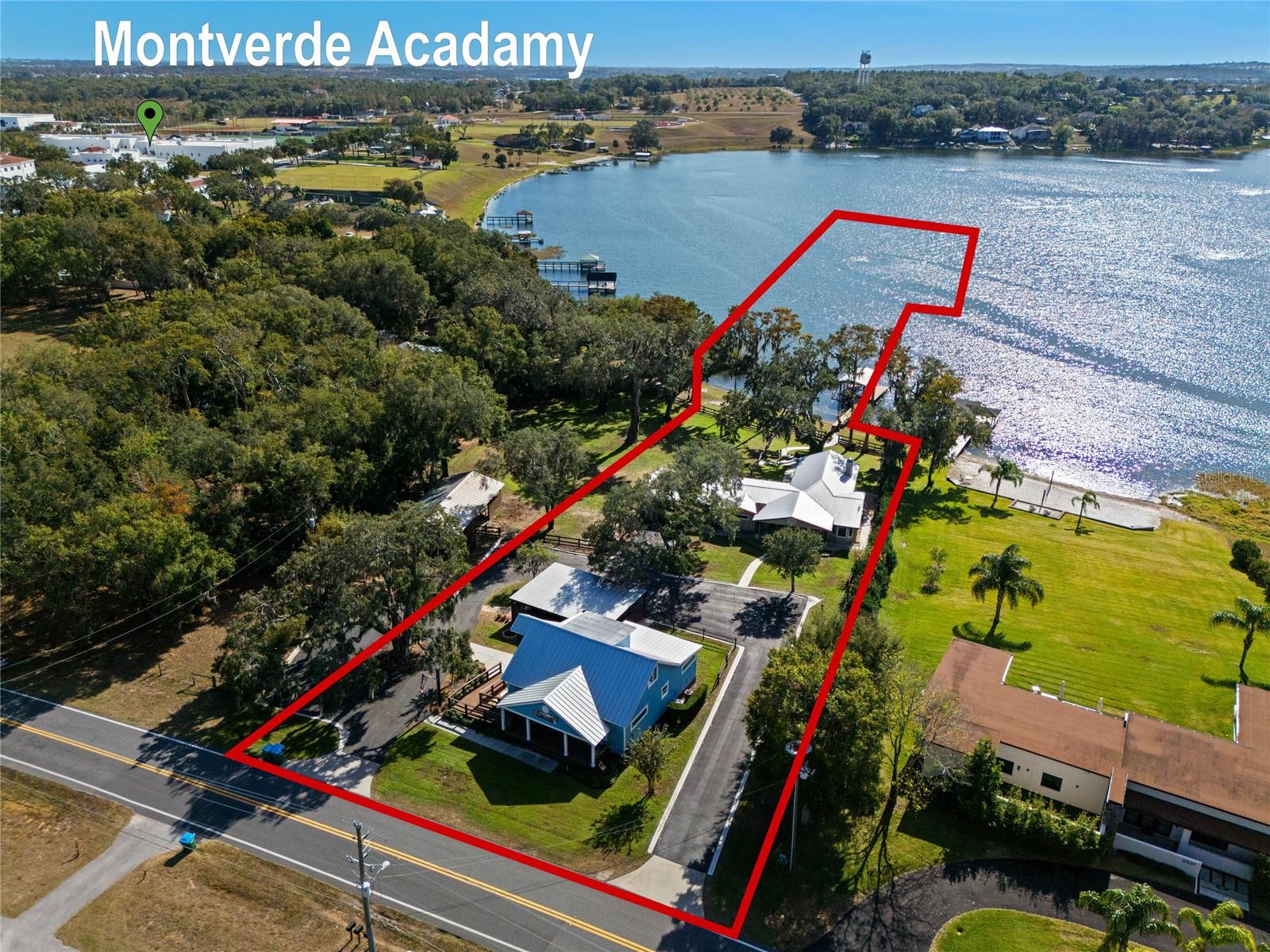 MONTVERDE hacienda offers ONE lakefront home, ONE commercial office & ONE lakefront buildable lot on LAKE FLORENCE! All parcel combined total 9.07 acres however only 1.33 acres are dry. The Lake house sits on .52 of an acre, the additional buildable lakefront lot is .29 of an acre and the commercial office sits on .52 of an acre with the remaining of the property in the lake. FIRST is the three bedroom~two bath LAKEFRONT HOME with 2337 heated SF & offers AMAZING VIEWS with LARGE picturesque windows to show off the lake and offer a panoramic high elevation view. The custom kitchen has solid wood cabinets (with plenty of storage with roll out shelves), quartz counter tops and stainless steel built in commercial KITCHEN AIDE appliances, including a separate drawer refrigerator AND an ice maker, for lake living! The living room is oversized with beamed cathedral ceilings and once again amazing views of the lake. Enjoy the wood burning stacked tile fireplace on those few Florida cold nights. The master bedroom measures a nice size, once again offers great lake views along with a nice sized walk in closet with custom adjustable shelving. The master bath has a walk in oversized shower with multiple shower heads, dual sinks & plenty of storage. The two remaining bedrooms are good size as well and one bedroom even has a barn door to offer a little privacy of that bedroom and the guest bath. The laundry room is OVERSIZED and could easily double as a craft room. Wood looking plank tile, crown molding and 5 1/4" base throughout. EXTENDED two car garage plus a garage door off the back to offer a great lake cross breeze ventilation while tinkering in the garage. Plenty of additional storage under the living room with exterior access. Enjoy the brick fire pit and lake views under the LARGE OAK TREES after a long day. The property is complete with a covered boat dock including hoist with power and water. METAL roof and AC was installed in 2018. NEXT is the buildable LAKEFRONT lot that measures .29 of an acre and you can't but notice the granddaddy OAK TREES. This parcel does offer a private boat ramp and you can BRING ANY BUILDER & NO TIME LIMIT to build. This parcel has a barn that measure approximately 1104 square feet and has two oversized stalls, two storage rooms additional covered space. LASTLY is the commercial office space which is zoned ORC, Office Residential Commercial. The property can be used as commercial OR residential! The building is 1892 SF heated & is currently being used as as office space however there are many options on the permitted use list. It currently has a reception area, three large office rooms, conference room, full size kitchen (complete with kitchen appliances) & an upstairs BONUS room currently being subleased. The bonus room has a kitchenette area, complete with a kitchen sink and drawer fridge. The bonus room space has a separate exterior entrance as well as an interior entrance and can be locked off. This building has two full bathrooms and one half bath. The building can also be used as a residence and would be a three bedroom ~ two full bath and one half bath and is pre plumbed/wired for a shower and stackable laundry in the handicap bathroom. Office completely remodeled in 2015. PLENTY of parking as well as an additional three bay carport. Entire property is fully irrigated by a 5 horse power pump from the lake plus multiple lamp post throughout to offer a nice evening ambiance. A MUST SEE!