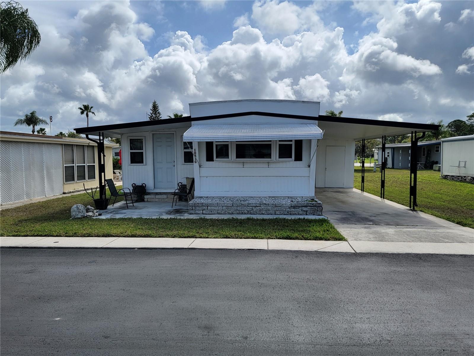 SELLER FINANCING with reasonable terms to fit your budget for this ABSOLUTELY STUNNING & TURN-KEY! Welcome home to this meticulously updated residence at 10810 Tioga Dr nestled in the highly sought-after, gated 55+ cooperative of Senate Manor. This is Florida living at its absolute finest! Step inside to discover a bright and airy OPEN FLOOR PLAN that radiates a "brand new" feel. This home has been thoughtfully renovated with modern living in mind, featuring gorgeous luxury vinyl plank (LVP) flooring throughout for a seamless look. The heart of the home is the fully renovated kitchen boasting crisp cabinetry, stylish countertops perfect for whipping up a meal before heading to the pool or a community event! The spacious floor plan includes a versatile Florida Room that easily serves as a den, hobby room, or guest retreat. The primary suite is a peaceful sanctuary, complemented by a beautifully updated bathroom featuring a modern vanity and a spacious low step-in shower. Some of the exterior highlights are the covered carport parking with rain gutters and has durable skirting to keep your home pristine. It also has a large storage shed/workshop with laundry hookups. The community has some perks too like a low $200/MONTH HOA FEE, you get it all! The fee covers water, sewer, lawn care, and twice-weekly trash/recycling. Enjoy world-class amenities including a heated pool & spa, fitness center, shuffleboard, and a vibrant clubhouse with a full social calendar of Bingo, potlucks, and Taco Tuesdays! There is even optional on-site storage for your boat or RV for an additional fee. Located just minutes from pristine Gulf beaches, premier shopping, and dining, this home is MOVE-IN READY and waiting for you. Whether you’re looking for a seasonal escape or a forever home, this Senate Manor gem is a MUST-SEE! SCHEDULE YOUR SHOWING TODAY!