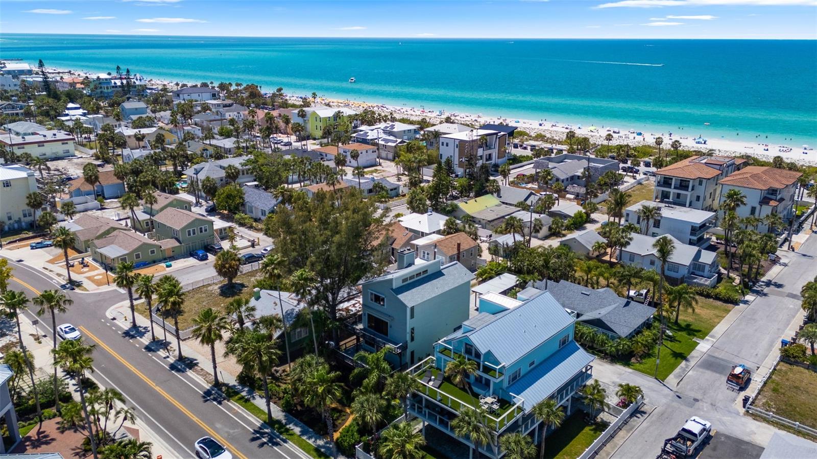 Paradise Lost?  You just found it - right here in the heart of Historic Pass-A-Grille Beach.  This charming beach house is giving off vacation vibes all day long!  With three elevated levels of living area and water views from nearly every room, you will have a hard time choosing your favorite spot!  A warm welcome through the front courtyard and the covered entry is a perfect place to display your seashells and succulents.  The interior foyer has a large storage closet and leads to the main living level.  The large living room has a wood burning fireplace opens to the east facing porch with breathtaking views of the intracoastal waterway.  The dining room has built in storage and a green house window with loads of natural northern light for an indoor herb garden.  The updated kitchen has plenty of prep and storage space and a side door the the back garden.  The second living level has another sitting room on the sunrise side with sliding doors to the balcony.  Two spacious bedrooms share a large hall bath with double vanity and separate water closet with tub and shower.  One of the two bedrooms has a wood burning fireplace and walk in closet, the other has been used as an art studio with gorgeous western light!  A laundry room on this floor has full sized washer and dryer and built in storage.  The primary suite is located on the upper level with a fireplace, walk-in closet, ensuite bath and water views from three sides! Sliding doors form the Primary Suite lead to a huge private porch overlooking the Gulf.  Alley access for the attached two car garage. The lovely large lot has low maintenance landscaping and irrigation.  This beach retreat is just steps from the beach and a few blocks from shopping and restaurants.