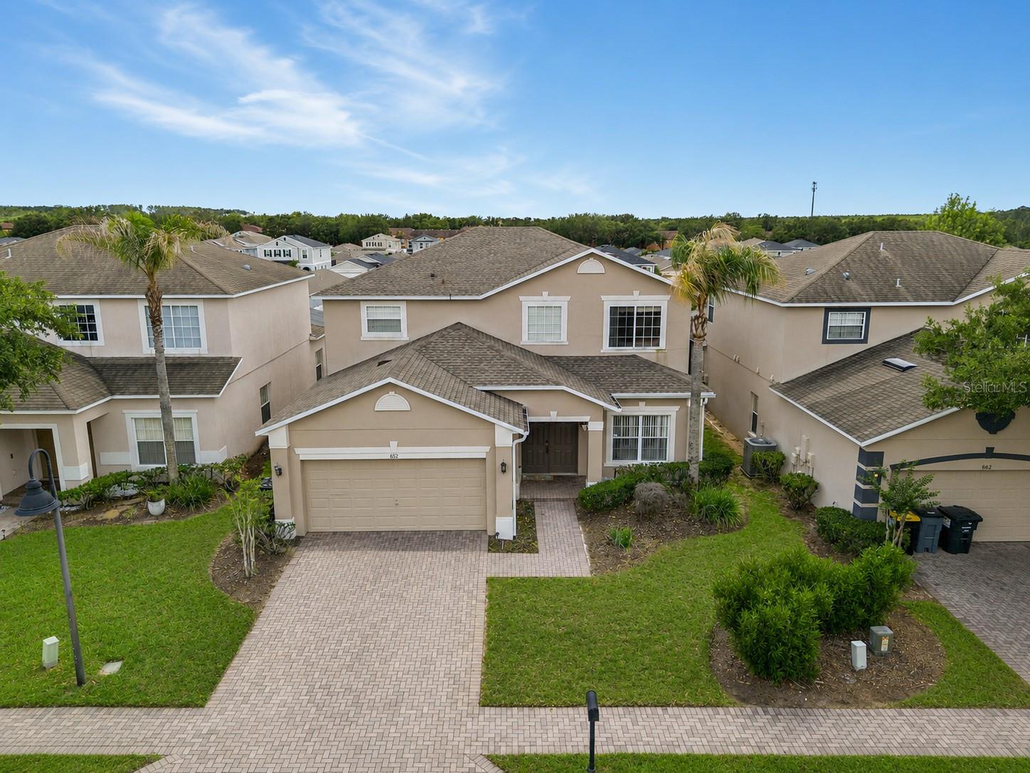 Discover your Florida oasis at 652 Highgate Park Boulevard, a beautifully maintained 5-bedroom, 4-bath home located within the gated Highgate Park section of Legacy Park. Featuring a heated pool and spa, Roof Replaced (YEAR), updated appliances, and a well-maintained HVAC system, this exceptional property offers the perfect blend of comfort, convenience, and flexibility as a primary residence, vacation home, or investment opportunity.

Spanning nearly 2,500 square feet, the interior offers a versatile floor plan designed for both everyday living and effortless entertaining. The heart of the home is a contemporary kitchen showcasing modern finishes, ample counter space, and a striking waterfall-edge quartz island that serves as a natural gathering place for family and guests. Just off the family room, a convenient wet bar enhances the home's entertaining appeal, creating the perfect setup for hosting family and friends.

Step outside to your private backyard retreat, where an expansive screened lanai surrounds the heated pool and spa, creating the perfect setting for year-round relaxation, outdoor dining, and making lasting memories with family and friends.

Highgate Park is one of the most sought-after gated communities within Legacy Park, offering an ideal location near ChampionsGate, premier golf courses, shopping, dining, grocery stores, medical facilities, and major highways including US-27 and I-4. Residents enjoy the convenience of HOA-maintained lawn care and trash service, making ownership even easier whether you're living here full-time, using the property as a vacation home, or adding it to your investment portfolio.

Located just a short drive from Walt Disney World and Central Florida's world-famous attractions, this exceptional home delivers the perfect balance of comfort, convenience, and Florida lifestyle. Call today to schedule a private tour.