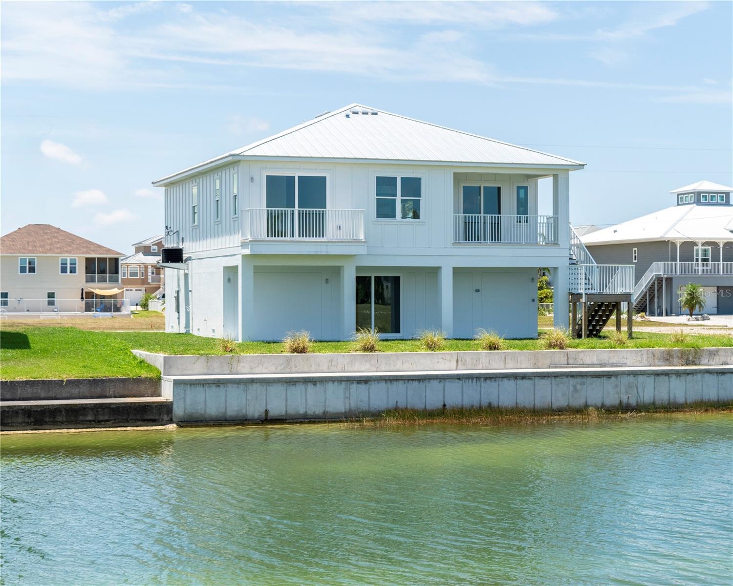 Pre-Construction. To be built. Pre-Construction, To-Be-Built, Custom Home ? 75 Feet of Water Frontage. Imagine being tucked away in the serenity of Hernando Beach South; you hear the water in the canal behind you, and the birds are singing. This coastal lover's dream features 3 beds, 3 baths, 1,600 sq ft under air, and an oversized 3-car garage. Enjoy multiple balconies, a large covered rear patio overlooking the canal, LVP flooring, and porcelain tile in the bathrooms. The master suite boasts a tray ceiling, walk-in closet, double vanity, and walk-in shower. The kitchen features soft-close cabinets, a range with hood, and stainless-steel appliances. Luxury standards include 5 1/4 inch baseboards, tankless electric water heater, low-e impact windows, and a future elevator shaft design in the plans. The home is fully customizable, with upgrade options including a pool. Estimated completion is approximately 10 months from ground break. Lot also available for separate purchase.