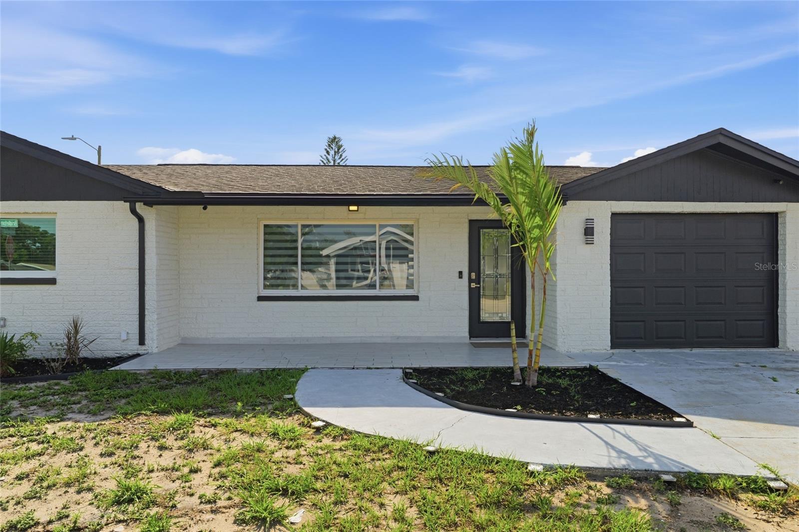 MOVE-IN READY in Port Richey! Beautifully updated 3-bedroom, 2-bath home featuring an open floor plan with modern lighting, fresh interior and exterior paint, and a spacious enclosed screened porch perfect for relaxing or entertaining. The oversized backyard offers plenty of space for a future pool, trailer, or boat parking. Major updates include NEW A/C and ductwork (2022), roof (2017), refrigerator, stove, and microwave (2022), plus a water heater replaced in 2022. All windows include blinds for added privacy and convenience. Property is connected to public water and also features a private well that only needs pump and electrical connection installation. Conveniently located near US-19, shopping, restaurants, medical facilities, and just a short drive to Weeki Wachee Springs and Gulf Coast beaches. NO flood insurance required and NO HOA! Excellent opportunity for a primary residence, investment property, or Airbnb potential. Don’t miss the chance to own this beautifully maintained Florida home situated on a desirable corner lot with room for boat or trailer storage!