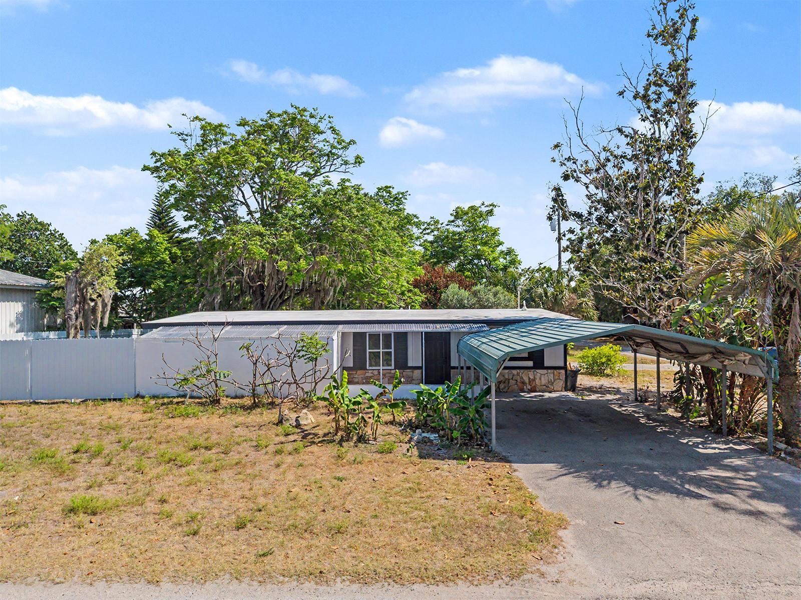 Beautifully remodeled and move-in ready, this 3-bedroom, 2-bath home sits on a desirable corner lot with no HOA and no CDD. Thoughtfully renovated throughout, the home features a stunning new kitchen with modern shaker cabinetry, new countertops, stainless steel appliances, luxury vinyl plank flooring, recessed LED lighting, and beautifully updated bathrooms, including a spacious walk-in shower. The primary suite features a sliding glass door leading directly to the backyard, while one of the secondary bedrooms offers elegant French doors with backyard access, filling the home with natural light and creating a seamless indoor-outdoor flow. Situated on a fully fenced .26-acre lot, the property offers plenty of space for entertaining, pets, gardening, or storing your boat or recreational vehicles. Additional features include an indoor laundry room with washer and dryer hookups, a covered carport, and ample parking. Conveniently located just minutes from Hudson Beach, marinas, restaurants, shopping, and everyday conveniences, this beautifully updated home is ready for its new owner. Schedule your private showing today!