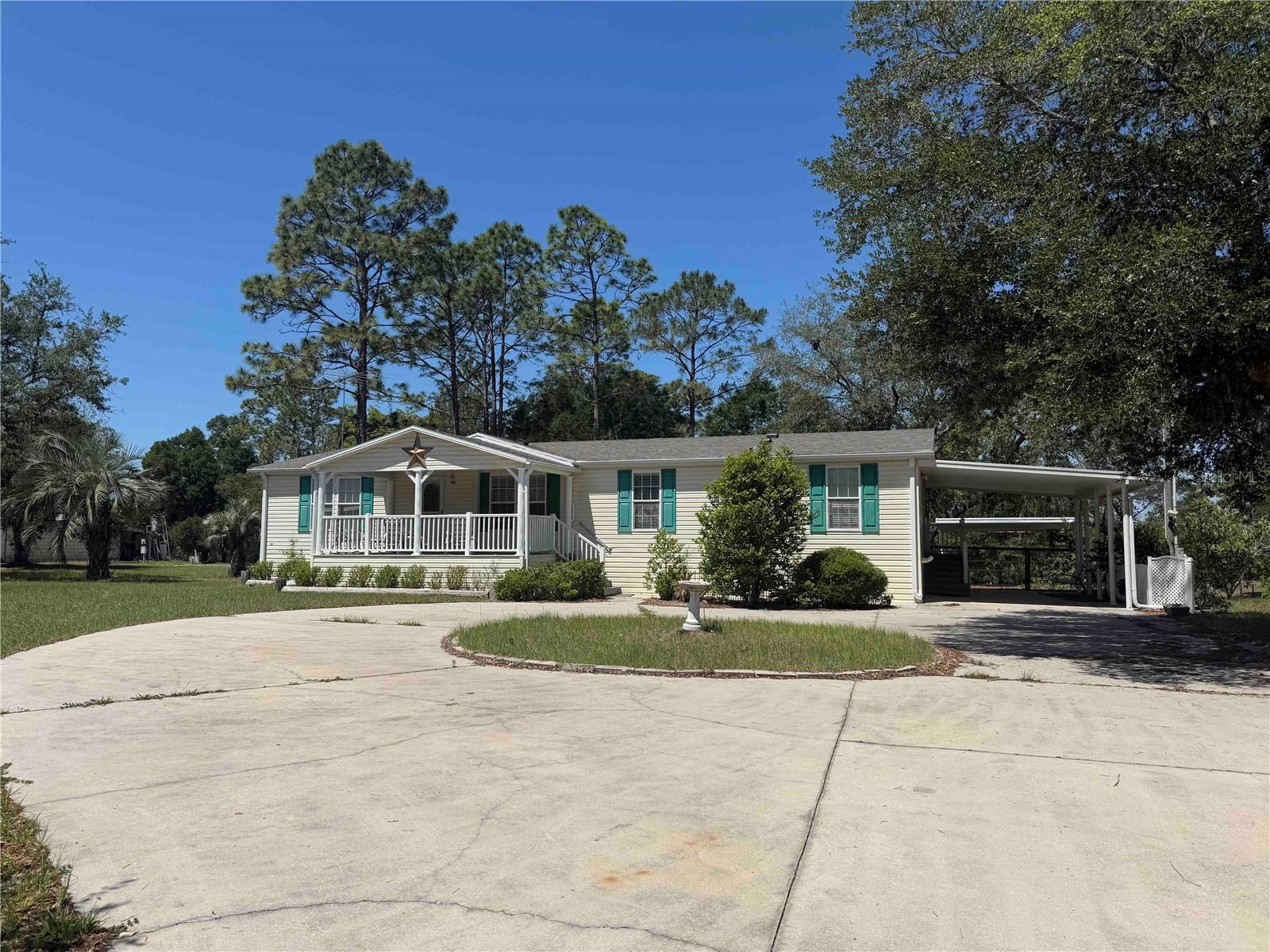 Beautifully set on 2.56 oak-dotted acres along a paved road in the desirable Small Farms community, this charming 3-bedroom, 2-bath home offers the perfect blend of comfort, privacy, and versatility. With 1,620 square feet of living space, the open split floor plan features both a living room and a family room, creating flexible spaces for everyday living, entertaining, or working from home. The spacious eat-in kitchen is fully equipped and ideal for gathering with family and friends. Step outside to the inviting porch and enjoy peaceful views of the gorgeous oak-studded landscape—perfect for morning coffee or relaxing evenings. Tucked near the end of a quiet dead-end street, the setting offers exceptional privacy and tranquility. The property includes a 35x24 metal building for a workshop, storage, or hobbies, along with a full RV hookup. Recent upgrades include a 2022 HVAC system, 2025 water heater, 2026 well pump, and 2026 new roof, providing added peace of mind. With no HOA and plenty of room for outdoor living, animals, or toys, this property offers endless possibilities. Conveniently located just 14 miles to Dunnellon, 22 miles to Ocala, and approximately 35 miles to Gainesville—enjoy peaceful country living with easy access to town.