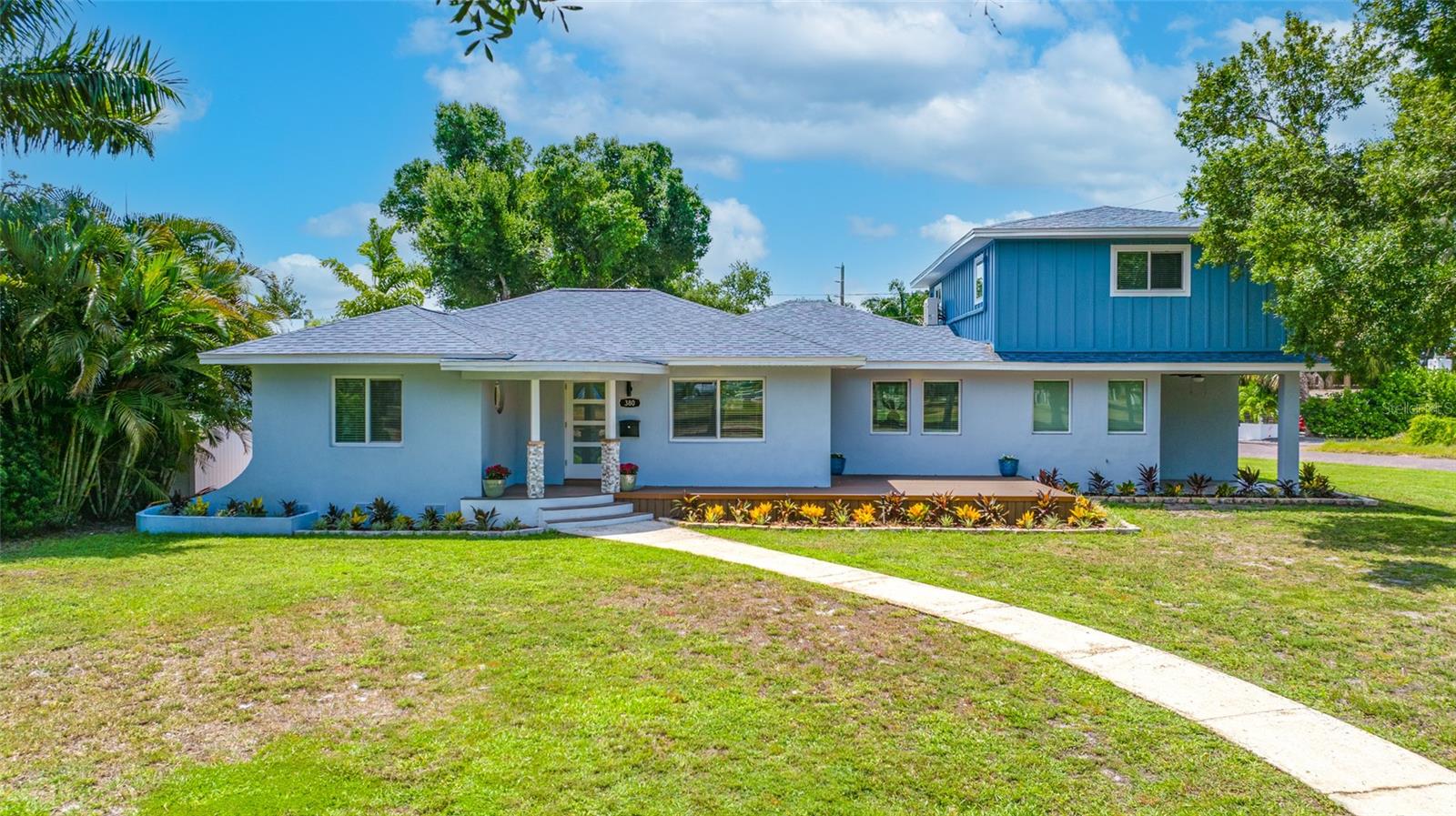 Welcome to this beautifully renovated, move-in-ready home that seamlessly combines modern luxury, exceptional craftsmanship, and outstanding income potential. The main residence offers 4 bedrooms, 3 bathrooms, and a thoughtfully designed open-concept floor plan enhanced by premium finishes throughout. Features include hurricane-impact windows, luxury laminate flooring, quartz countertops, soft-close wood cabinetry, crown molding, recessed lighting, tankless water heaters, custom glass shower enclosures, and a 2023 roof and HVAC system.  The spacious primary suite serves as a private retreat, complete with an enclosed porch perfect for relaxing after a long day. The spa-inspired primary bathroom features dual vanities and an oversized walk-in shower with dual shower heads for a luxurious experience. 
Adding tremendous value is the detached 714 square feet, 1-bedroom, 1-bath guest suite located above the garage. This versatile space offers a private entrance accessed by a beautifully painted interior stairway mural, its own electric meter, a private ground-level patio with a dedicated laundry closet, making it ideal for rental income, multigenerational living, extended guests, or a private home office. Situated on an oversized corner lot of 15,394 square feet along a charming brick-paved street, the property also features an epoxy-coated one-car garage, a welcoming front deck, and ample outdoor living space that is great for entertaining or quiet relaxation. Ideally located just minutes from vibrant downtown, award-winning Gulf beaches, shopping, dining, parks, schools, and major commuter routes, this exceptional home offers the perfect balance of convenience and peaceful neighborhood living.  Beautifully renovated with designer finishes and a highly desirable income-producing guest suite, this one-of-a-kind property is truly move-in ready and presents a rare opportunity to own a versatile, turnkey home in one of the area's most sought-after locations.