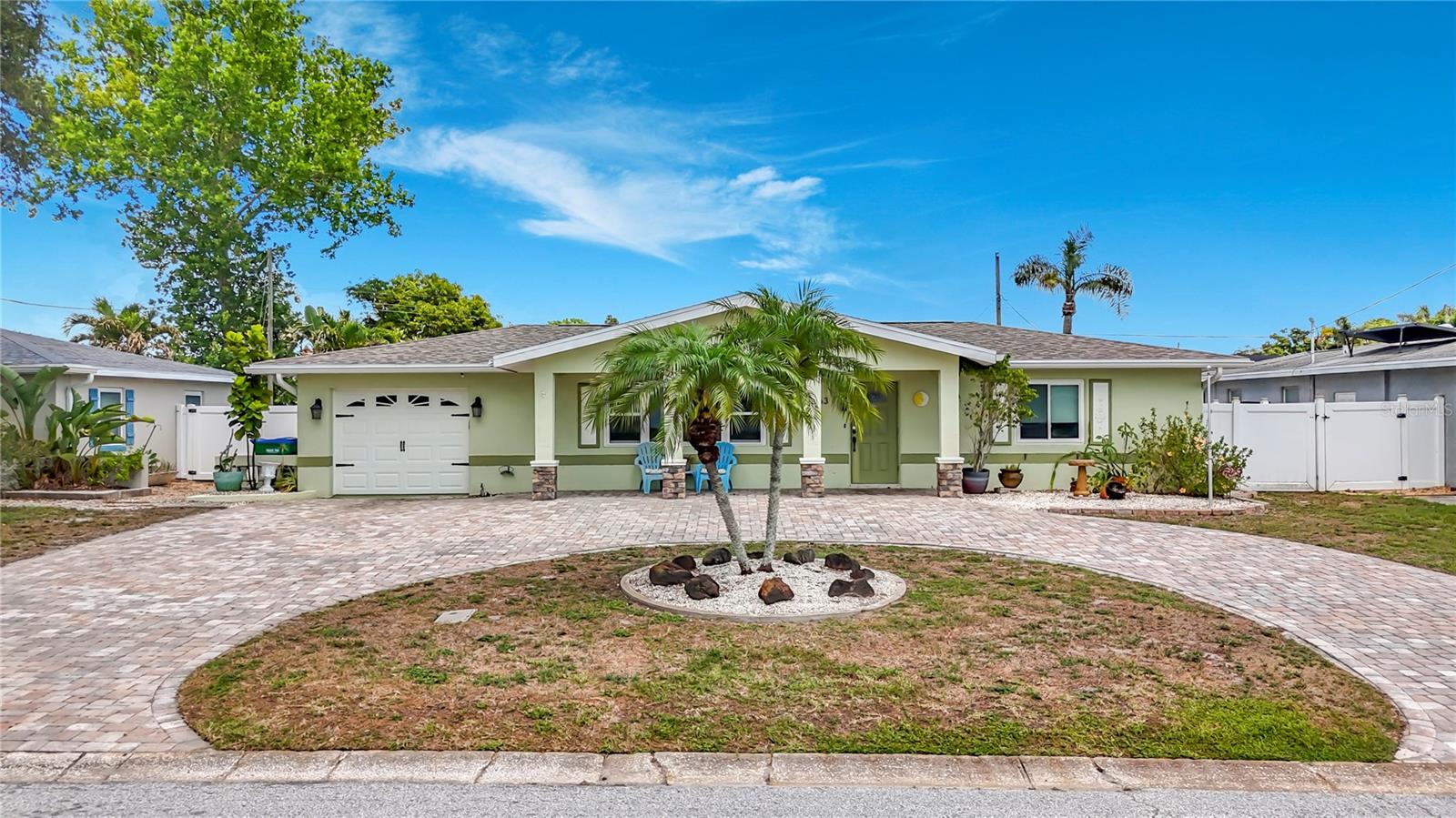 Virtually Staged. Nestled in one of Kenneth City’s most sought-after waterfront locations, this beautifully expanded and renovated 3-bedroom, 2.5-bath home offers over 2,000 square feet of comfortable living space with serene water views and exceptional indoor-outdoor living.

Originally transformed in a major 2017 renovation that nearly doubled the size of the home, this residence blends modern functionality with classic Florida charm. Inside, you’ll find spacious living areas filled with natural light, an interior laundry room, and a versatile Florida room overlooking the water — the perfect place to enjoy morning coffee. The screened-in patio creates additional space for relaxing or entertaining year-round while taking in the peaceful waterfront setting.

Additional highlights include a one-car garage, attractive paver circular driveway, and two outdoor storage sheds including a Tuff Shed and Wally Watt shed for ample storage and workspace.

Ideally located close to restaurants, shopping, beautiful Gulf beaches, and convenient highway access, this move-in-ready lakefront property offers the perfect combination of location, space, and lifestyle in the heart of Pinellas County.