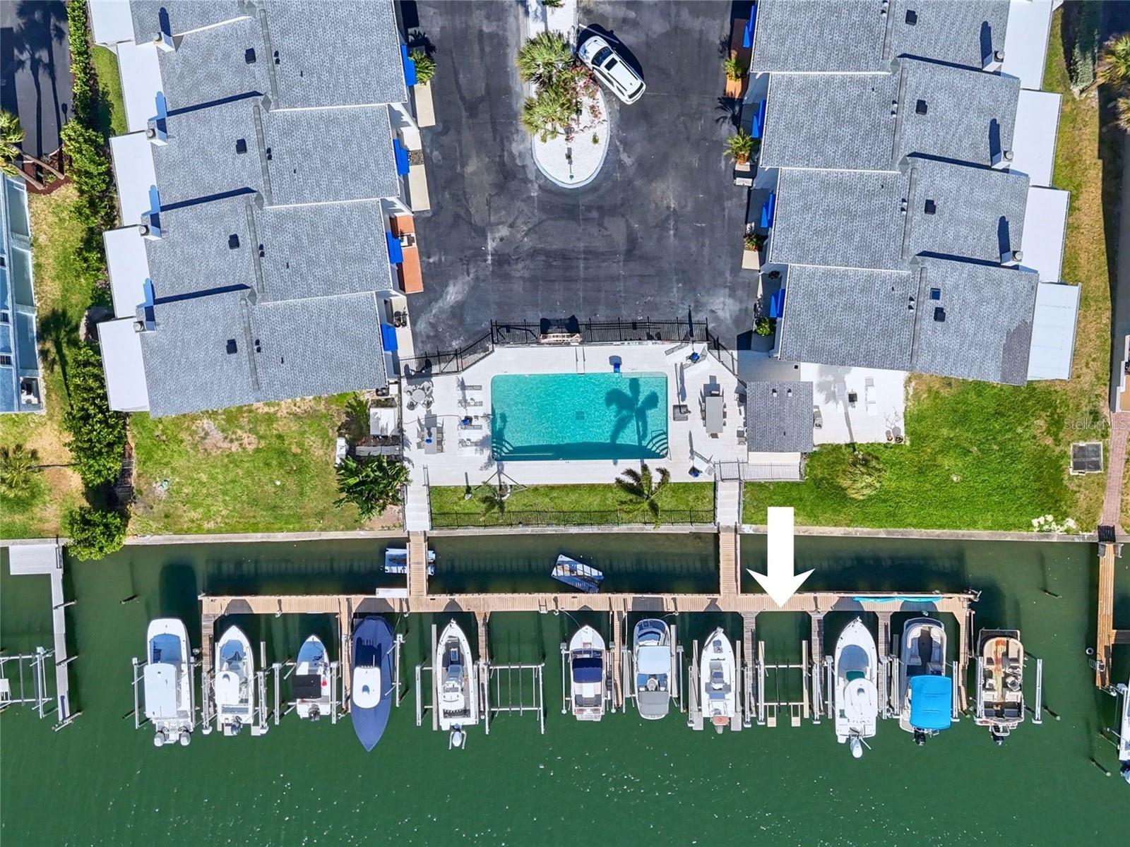 Two-bedroom townhome with deeded boat slip & 10,000 lbs lift in a great waterfront community featuring a recently updated heated water-side pool and updated dock. This multi-level unit offers a functional layout with a bonus room and private garage, providing flexibility for storage, workspace, or future improvements. The main living level features an open living and dining area with dark wood flooring, centered around a wood-burning fireplace. French doors with nice shades open to an oversized balcony with some water views, creating a comfortable indoor-outdoor living space. The kitchen includes a breakfast bar and movable island, with all ready to use appliances. A powder room is also located on this level.
Upstairs, the primary bedroom includes its own balcony with partial water views, along with an ensuite bathroom featuring a large walk-in shower and double sink vanity. The second bedroom is positioned on the opposite side for privacy and includes its own bathroom, ample closet space, and a built-in Murphy bed for quick transformation from office to a great guest bedroom. From this room, enjoy fantastic water views overlooking the pool, docks and the canal. A full-size laundry area is conveniently located on the bedroom level.
The property could use some updates and is being sold as-is, making it a solid opportunity for buyers looking to renovate and add value.
Ready to use deeded boat slip with 10,000 lbs lift, offering direct access to deep water and the island lifestyle.
Perfectly positioned within this coastal pet friendly community, just moments from waterfront dining and scenic biking path, short drive to downtown Petersburg and only 40 minutes to Tampa International Airport.