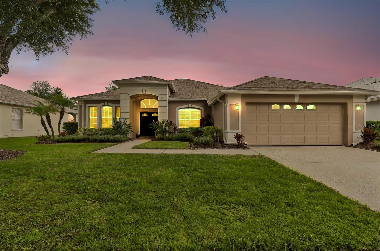 Welcome to Arbor Greene, one of New Tampa’s most sought-after guard-gated communities, where luxury, comfort, and breathtaking sunsets come together in perfect harmony.
Lovingly cared for and filled with years of happy memories, this exceptional 4-bedroom, 3-bathroom pool home is ready to welcome its next chapter. Perfectly positioned on a premium pond-view lot with conservation frontage, you'll enjoy spectacular sunset views from your backyard oasis every evening.
Designed for both everyday living and entertaining, the home features soaring high ceilings, an open-concept layout, and a highly desirable three-way split floor plan that provides privacy and functionality for family members and guests alike. Natural light pours throughout the home, highlighting the crown molding, updated finishes, laminate flooring, and inviting living spaces.
At the heart of the home is a beautifully renovated gourmet kitchen featuring custom cabinetry, granite countertops, glass tile backsplash, stainless steel appliances, gas cooktop, wine refrigerator, walk-in pantry, breakfast bar, and an eat-in dining area overlooking the sparkling pool and serene pond beyond. The kitchen flows seamlessly into the spacious family room, creating the perfect setting for gathering, entertaining, and everyday living.
The spacious primary suite offers private lanai access, custom walk-in closets, double vanities, a garden tub, and a glass walk-in shower, creating a peaceful retreat at the end of the day.
Step outside to your expanded pool and lanai surrounded by lush landscaping, pavers, tranquil water views, and unforgettable sunsets reflecting across the pond. Whether hosting friends or enjoying a quiet evening by the pool, this outdoor space was designed to be enjoyed year-round.
A standout feature is the transferable solar panel system, helping significantly reduce monthly electric costs while providing long-term energy savings. The home also includes a Tesla charger, irrigation system, water softener, gutters, drainage system, resurfaced pool (2026), and numerous interior upgrades throughout. Major updates include a 3-year-old roof and tankless electric water heater.
Residents of Arbor Greene enjoy resort-style amenities including tennis courts, fitness facilities, resort and fitness pools, scenic nature trails, parks, and a beautiful community clubhouse. Ideally located near Wiregrass Mall, top-rated dining, shopping, hospitals, entertainment, the new performing arts center, major highways, USF, Downtown Tampa, and Tampa International Airport.

More than just a home, this is a place to create lasting memories, enjoy spectacular sunsets, lower utility costs, and experience the very best of Florida living!