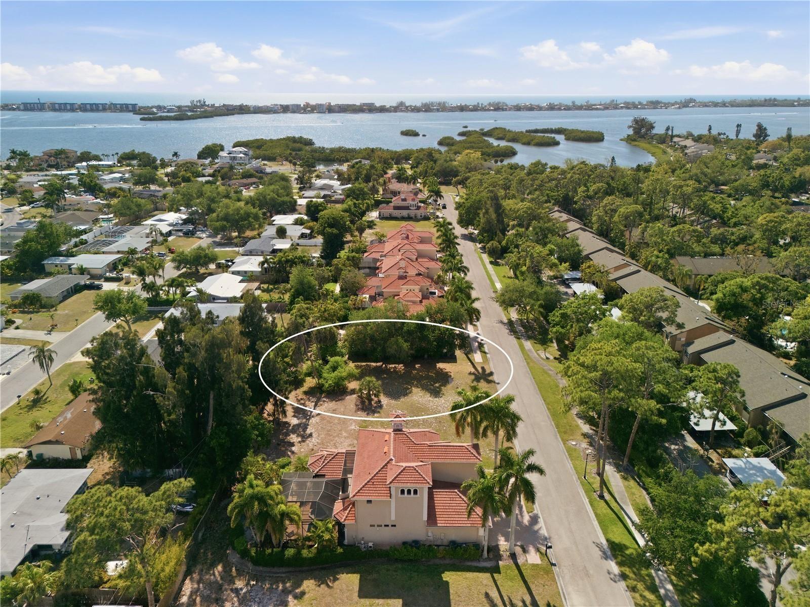 Located in the highly sought-after Portofino on the Bay neighborhood in Sarasota, this cleared homesite presents a rare opportunity to build your dream home in one of the area’s most desirable coastal communities. The property has already been cleared and is ready for construction, offering a smooth and convenient start for your custom build.

A builder of your choice can be selected, however plans have been made for this lot - an option of a 3,357 sq. ft. home, providing the opportunity to streamline the building process with a thoughtfully designed home. Buyers may choose to utilize the existing plans or customize them to suit their vision and lifestyle. Building plans must be approved by the board group of the community. The property is also located within the district for the highly regarded Pine View School, along with other highly rated public and private schools nearby.

This private and gated neighborhood is great for boaters, offering community deeded access to the bay and a community day dock, that is available upon reservation. Enjoy direct access to the Intracoastal Waterway. Boat slips could potentially become available for purchase if a community member is selling.

Located just 2 miles from downtown Sarasota, residents enjoy quick access to vibrant dining, shopping, and entertainment while still enjoying the privacy and tranquility of this waterfront-friendly community.