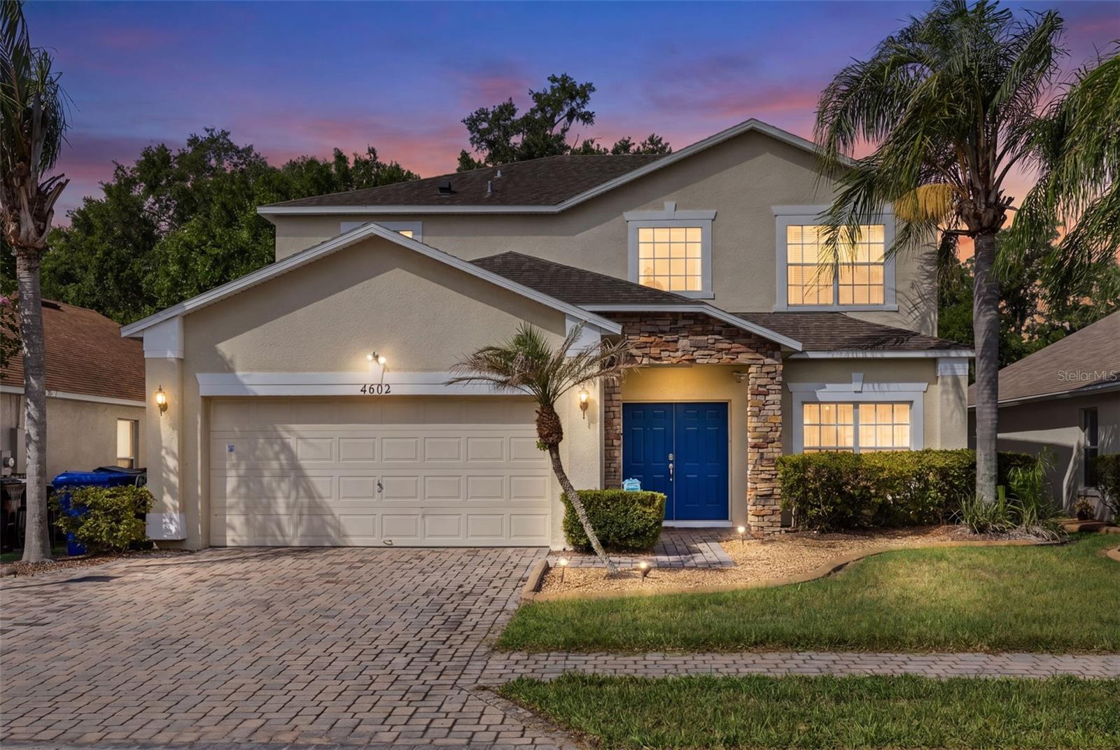 Welcome to 4602 Cumbrian Lakes Drive, a beautifully maintained and fully furnished 5-bedroom, 5-bathroom pool home located in the gated Cumbrian Lakes community, just minutes from Walt Disney World, shopping, dining, and Central Florida’s top attractions. Originally built as the community’s model home, this spacious residence offers over 2,600 square feet of living space with soaring vaulted ceilings, an open and functional floor plan, and a premium conservation lot with peaceful nature preserve views and no rear neighbors. The community features scenic walking trails through the preserve, including a charming bridge overlooking the pond, providing the perfect setting to enjoy Florida’s natural beauty. Recent upgrades provide exceptional value and peace of mind, including a new Carrier A/C system and furnace (2024), roof replacement (2018), pool heater (2025), updated GFI outlets with USB ports (2024), luxury vinyl flooring, fresh interior and exterior paint, new pool enclosure screens, keyless entry, security system, and new televisions throughout. The thoughtfully designed floor plan features two bedrooms on the first floor, while upstairs you'll find the expansive primary suite complete with a spacious ensuite bathroom, dual closets, and a huge private balcony overlooking the conservation area, along with two additional guest bedrooms. The kitchen is equipped with stainless steel appliances and a breakfast area, while the generous living and dining spaces are ideal for entertaining and everyday living. Step outside to your private screened-in pool retreat featuring a child safety fence, outdoor shower, convenient pool bath, and newly installed grab bar. Short-term rentals are permitted, making this property an excellent primary residence, vacation getaway, or income-producing investment opportunity. For qualified buyers, the existing VA loan assumes at 5.75%, an attractive interest rate, subject to lender approval and buyer qualification.