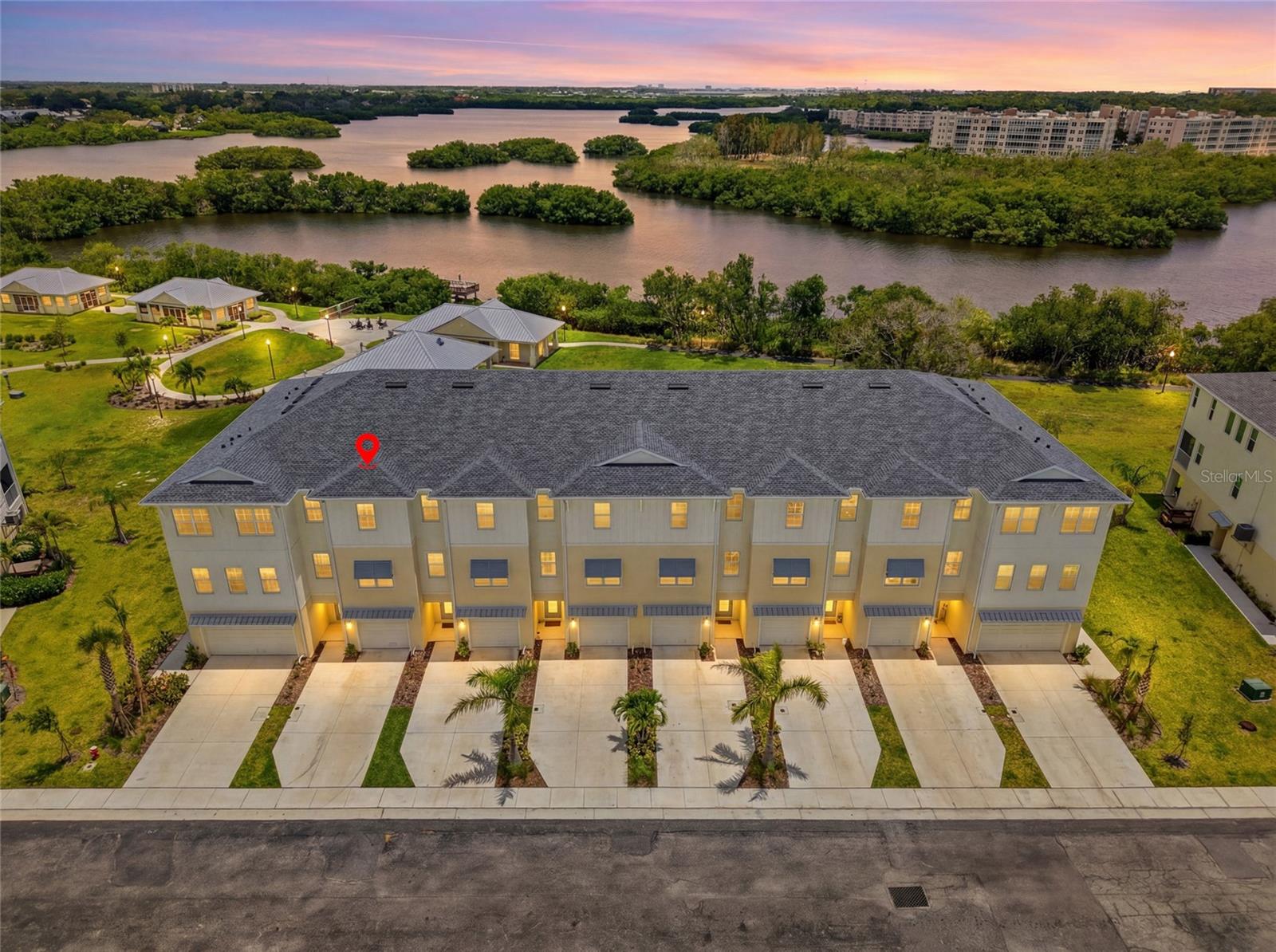 Experience elevated living in this stunning 3 Bedroom plus loft/office contemporary townhome, thoughtfully designed to offer the spacious feel of a single-family home with the ease of low-maintenance living. Built in 2024 and located within an exclusive gated waterfront community, this exceptional three-story residence perfectly blends modern elegance, comfort, and convenience. Step inside to discover a bright, open-concept design highlighted by soaring ceilings, luxury vinyl plank flooring, and expansive sliding glass doors that bathe the home in natural light. The heart of the home is the beautifully appointed gourmet kitchen, featuring custom cabinetry, a large quartz island ideal for gathering, upgraded stainless steel appliances, and abundant storage. Flowing seamlessly into the dining and living areas, this inviting space opens to a private balcony where you can relax and take in breathtaking water views. The second floor also offers a versatile flex space—perfect for a home office, reading nook, or sitting area—along with a conveniently located powder bath for guests. Upstairs, the spacious primary suite serves as a peaceful retreat, showcasing picturesque water views, an oversized walk-in closet, and a spa-inspired en-suite bath complete with dual vanities and an expansive walk-in shower. Two additional bedrooms, a full guest bath, and a conveniently located laundry room complete the third floor. Residents enjoy an impressive array of resort-style amenities, including a heated waterfront pool, clubhouse with fitness center, kayak launch, tennis courts, scenic walking trails, and a cozy community fire pit. Ideally situated just minutes from award-winning Gulf beaches, popular shopping destinations, restaurants, and local attractions, this remarkable home offers an exceptional opportunity to enjoy luxury waterfront living at its finest.