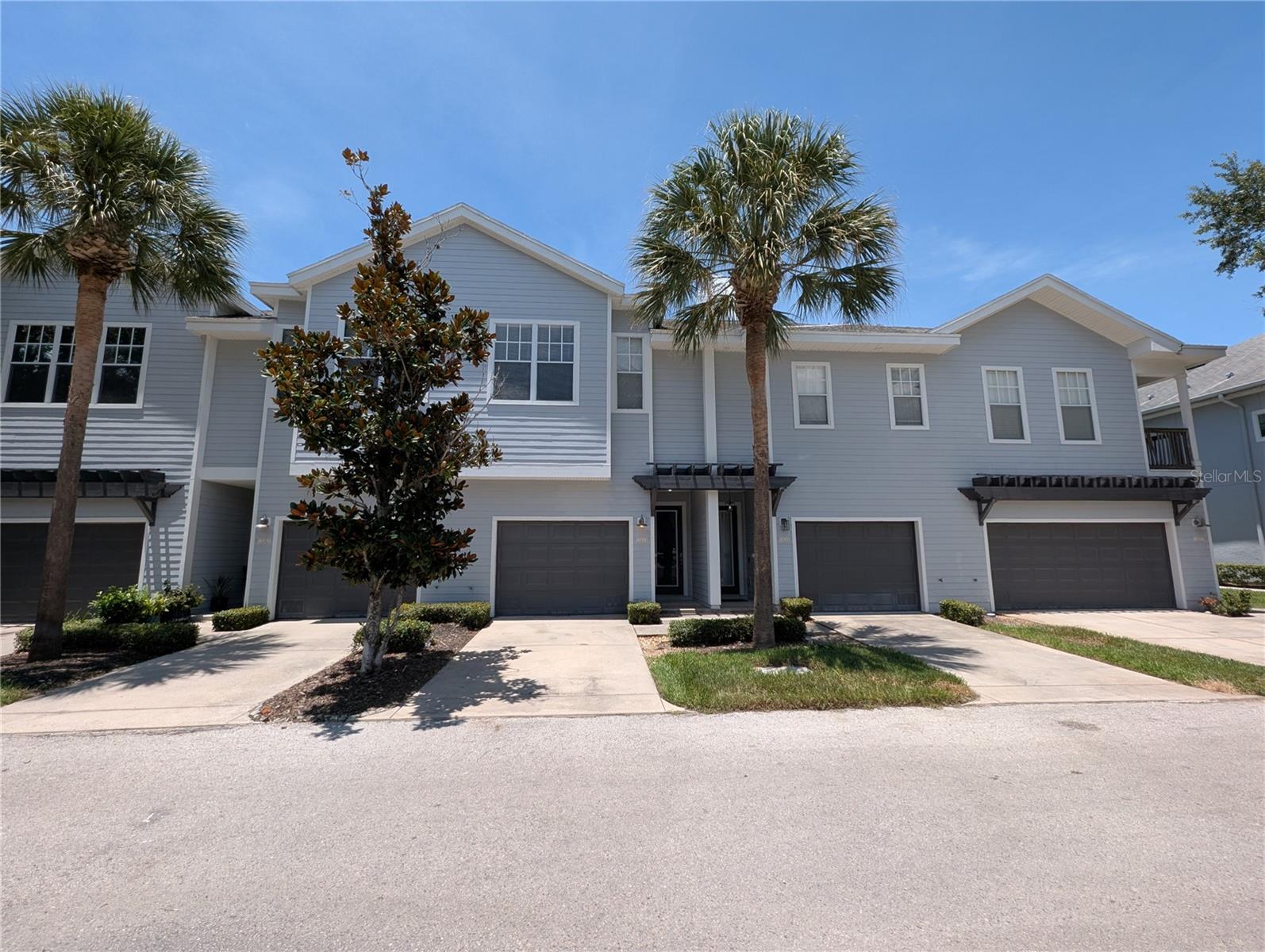 Nestled among mature trees in an exclusive community, this spacious 2-bedroom, 2.5-bath townhome offers 1,485 square feet of comfortable living with a unique and functional floor plan. Freshly updated with brand-new luxury vinyl plank flooring and carpet throughout, the home is move-in ready. Each level features a private bedroom with its own bathroom, providing excellent flexibility for guests, roommates, or a home office. The upper level showcases an open-concept living area filled with natural light, seamlessly connecting the spacious living room to the oversized kitchen, complete with abundant cabinetry, generous countertop space, and plenty of room for entertaining. Both bedrooms feature walk-in closets for ample storage, while the attached one-car garage keeps your vehicle protected from the Florida weather. Ideally located just minutes from Sheldon Road and Hillsborough Avenue, you'll enjoy convenient access to shopping, dining, parks, and major commuter routes.