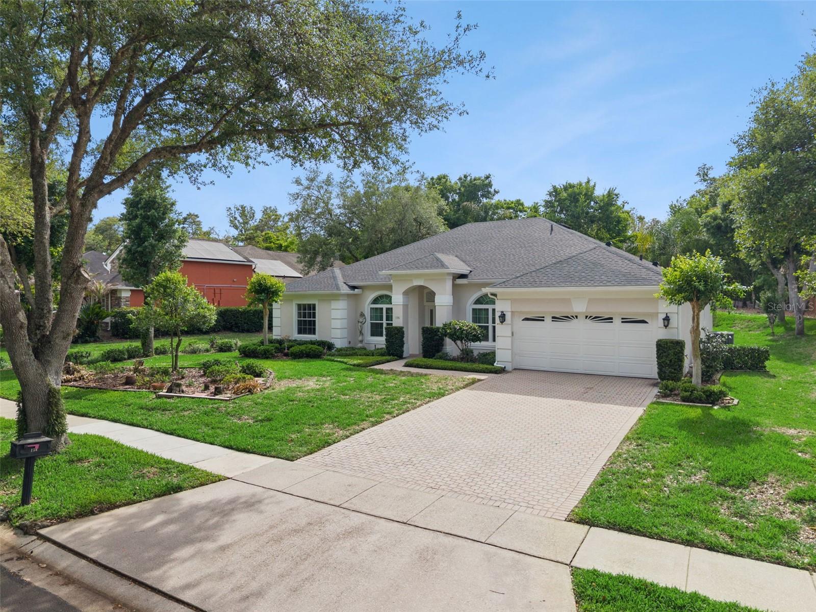 Virtually Staged. Welcome to refined Florida living in the exclusive gated community of Seville Chase, a hidden gem in desirable Winter Springs. With just 110 homes, this intimate community offers a rare blend of privacy, charm, and timeless appeal. As you enter, you’re greeted by the picturesque, tree-lined Seville Chase Drive, where mature landscaping and a serene community pond set the tone for a tranquil, elegant lifestyle. This beautifully designed one-owner, four-bedroom, three-bath residence features a highly sought-after three-way split floor plan, offering both comfort and privacy for family and guests alike. Thoughtfully laid out, the home flows effortlessly from one space to the next, creating an inviting atmosphere ideal for both everyday living and entertaining. From the moment you step inside, you’ll appreciate the sense of quiet sophistication—where natural light, spacious living areas, open concept kitchen, and well-appointed finishes come together in perfect harmony. The primary suite serves as a private retreat with ensuite bath that features a jacuzzi tub, separate shower, and walk-in closet, while secondary bedrooms are tucked away in separate wings, providing flexibility for guests, a home office, or multigenerational living. Whether enjoying peaceful mornings overlooking the surrounding greenery in your private screened lanai, or hosting gatherings in the generous living spaces, this home captures the essence of Florida living at its finest—where elegance meets ease in a setting that feels both luxurious and welcoming. Experience the beauty, privacy, and understated grandeur of Seville Chase—where every day feels like a retreat. This lovingly cared for home awaits your personal touches: ROOF (2023), HVAC (2022), 6 front impact WINDOWS and French PATIO DOORS (2024), water heater (2009), hurricane shutters, paver driveway, paver screened lanai.