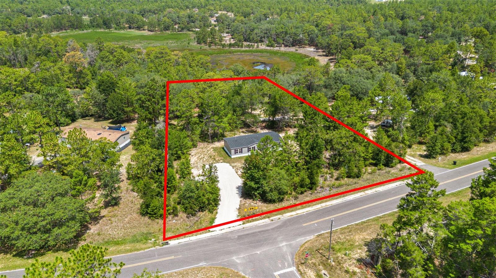 Looking for a BRAND-NEW HOME with land, privacy, and room for your animals? Welcome to 194 Whirlwind Loop, Hawthorne, FL—a never-lived-in 4-bedroom, 2-bath manufactured home on just over 2 ACRES that backs up to WHIRLWIND LAKE.

EVERYTING is BRAND NEW, including the home, appliances, septic, ROOF and HVAC, giving you the peace of mind that comes with new construction without the high price of a site-built home. The open-concept floor plan offers spacious living areas and the split-bedroom design provides added privacy. 

Step outside and enjoy the freedom that comes with AG zoning and NO HOA. Bring your horses, chickens, goats, or other farm animals and create the country lifestyle you've been dreaming about. A concrete slab is already in place in the backyard, making it easy to add a workshop, detached garage, RV storage, or an outdoor entertaining area.

Located on a PAVED road, this property offers quiet country living while remaining conveniently close to Gainesville, Palatka, and Ocala. Just minutes away is the charming town of Melrose, home to the stunning 6,000-acre SANTA FE LAKE. Spend your weekends boating, fishing, kayaking, paddleboarding, water skiing, tubing, or simply enjoying one of North Central Florida's most beautiful lakes.

Melrose is much more than a small town—it's a vibrant community known for its local restaurants, art galleries, boutiques, live music, festivals, art walks, farmers markets, craft classes, and year-round community events. Whether you're looking for outdoor adventure or a welcoming hometown atmosphere, you'll find it here.

If you've been searching for a move-in-ready home with acreage, lake views, room for your animals, and the freedom to live without HOA restrictions, this property checks all the boxes. Schedule your private tour today!
