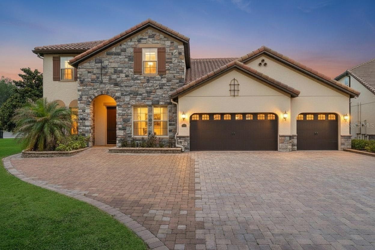 One or more photo(s) has been virtually staged. Welcome to Parkside in the heart of Dr. Phillips, where luxury, functionality, and exceptional outdoor living come together on a premium oversized lot. Offering over 4,000 square feet of thoughtfully designed living space, this beautifully updated 5-bedroom, 4-bath pool home blends elegant entertaining areas with comfortable everyday living.

Over the past four years, the home has undergone extensive upgrades, including fresh interior paint, new flooring throughout the entire home and staircase, updated lighting fixtures, a custom TV feature wall, upgraded garage finishes, and the complete transformation of a downstairs half bath into a full bath. Both AC systems have been replaced within the past year, providing added comfort and peace of mind.

Upon entering, you're welcomed by elegant formal living and dining spaces enhanced by striking wood beam ceilings that add warmth and architectural character. Beyond, the gourmet kitchen serves as the heart of the home, featuring an oversized island, granite countertops, 42-inch cabinetry, stainless steel appliances, a stainless vent hood, built-in coffee station, walk-in pantry, and abundant storage. The kitchen flows seamlessly into the spacious family room and breakfast area, creating an inviting gathering space with beautiful views of the pool, covered lanai, and expansive backyard.

The first-floor primary suite offers a private retreat, complete with a spa-inspired ensuite bath featuring dual vanities, a soaking tub, walk-in shower, and a generously sized walk-in closet with custom built-in storage.

Designed with functionality in mind, the home also features a dedicated mudroom with extensive cabinetry and storage, a wet bar for entertaining, and thoughtfully designed storage solutions throughout.

Upstairs, a spacious loft provides flexible living space, while the large L-shaped built-in workspace with custom wood cabinetry creates the perfect setting for a home office, study area, creative studio, or homework station. The secondary bedrooms are generously sized with walk in closets and are complemented by a Jack-and-Jill bathroom with private vanities for each bedroom. Two other spacious bedrooms upstairs have access to another bathroom with dual sinks and a shower. 

Step outside to your own private Florida retreat. The outdoor living space features a sparkling pool and spa, expansive travertine deck, custom screen enclosure, covered lanai, outdoor kitchen, and pool shower. The oversized fenced backyard provides abundant space for recreation, entertaining, pets, gardening, and enjoying Florida living year-round.

Residents of Parkside enjoy access to resort-style amenities including a clubhouse, community pool, tennis courts, soccer field, playground, and direct access to Dr. P. Phillips Community Park with walking trails, sports fields, and nightly Disney and SeaWorld fireworks views.

Ideally located near top-rated schools, Restaurant Row, shopping, world-class golf, major highways, and Orlando's premier attractions, this move-in-ready home offers the perfect combination of luxury, location, and lifestyle.