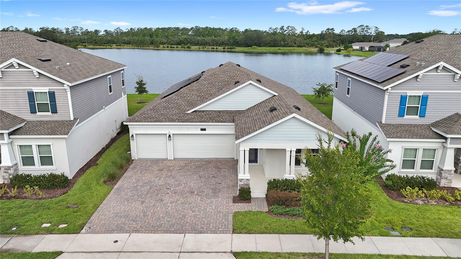 Welcome to 3084 Ella Way, a stunning 2022-built home situated on a premier waterfront homesite in the highly sought after and amenity-rich Bridgewalk community within St. Cloud's growing Sunbridge corridor. Lawn care is included in your HOA. This beautifully designed single story and split floor plan home features 4 bedrooms, 3 bathrooms, a 3-car garage, a spacious front porch, and over 2,600 square feet of thoughtfully designed living space. Its open concept floor plan is highlighted by soaring tray ceilings, creating a light-filled, spacious interior that's perfectly suited for both everyday living and effortless entertaining. The heart of the home is the stunning chef's kitchen with water views, featuring a large quartz island, white shaker-style cabinetry, abundant counter space, and seamless flow into the dining and living areas. Ceramic tile throughout the main living spaces provides both style and durability, while plush carpeting in the bedrooms adds warmth and comfort. There is also a formal dining room or flex space. Step outside to the true highlight of this home, a premium waterfront backyard with breathtaking pond views and a view of the community boat ramp. Whether you're enjoying your morning coffee, hosting friends, or relaxing as the sun sets over the water, this private outdoor retreat offers the perfect backdrop for Florida living. Located less than 15 min from Lake Nona, you'll enjoy convenient access to premier shopping, dining in Boxi Park, entertainment, and major roadways while still coming home to a peaceful, nature filled setting. Bridgewalk residents enjoy an exceptional resort-style lifestyle with amenities including a sparkling community pool, lap pool, fitness center, clubhouse, pickleball courts, playgrounds, scenic walking trails, a dog park, and a private boat launch.If you've been searching for the perfect combination of modern construction, a premium waterfront homesite, and an unbeatable community, 3084 Ella Way delivers it all.