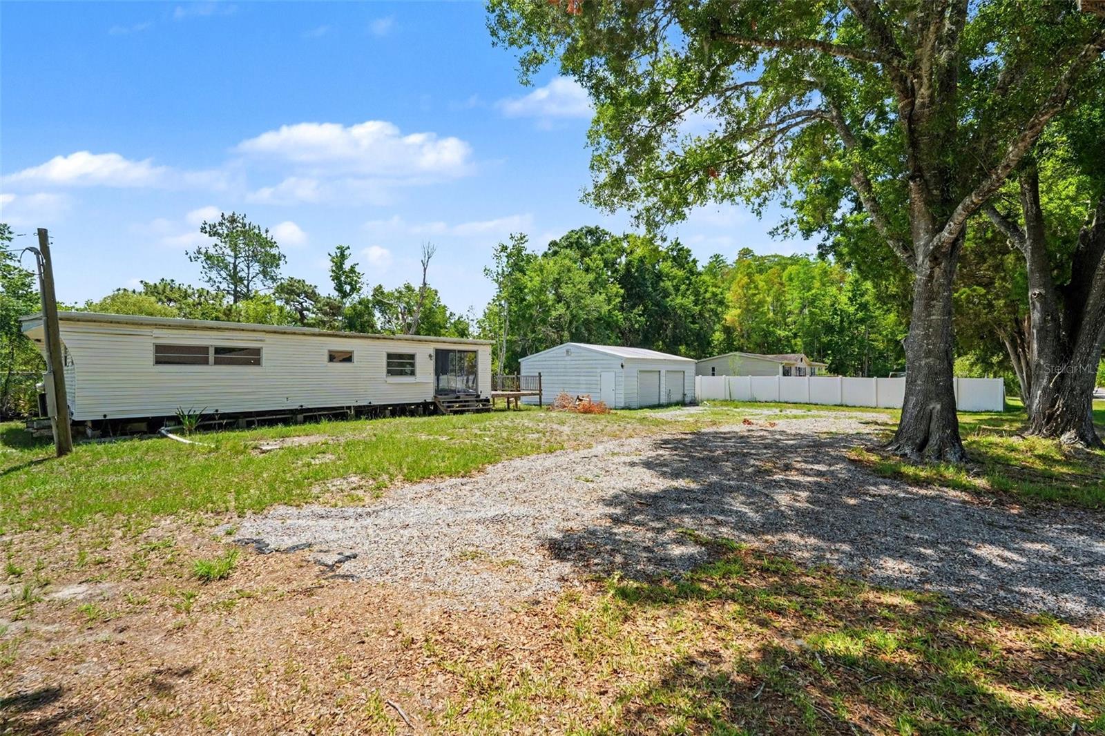 ****NO DEED RESTRICTIONS***** BEAUTIFUL 1 ACRE IN DESIRABLE NORTH LUTZ. Build the home of your dreams! Rare opportunity to own over ONE ACRE in the desirable Sierra Pines with NO HOA, NO CDD, and NO REAR NEIGHBORS! Tucked away in a peaceful country setting surrounded by custom homes and natural beauty, this property offers the perfect balance of privacy, flexibility, and convenience.

Whether you’re searching for a future homesite, investment opportunity, fixer-upper, or land to create your own private retreat, the possibilities here are endless. The spacious high-and-dry lot provides plenty of room for RVs, boats, animals, gardens, recreational vehicles, or additional structures — all without the restrictions of a typical neighborhood.

The property currently features a double-wide mobile home and a 750sf DETACHED GARAGE/WORKSHOP, offering functional space, storage, and immediate usability while you bring your vision to life. Existing well and septic are already in place, adding value and convenience for future plans.

Enjoy peaceful surroundings where deer, birds, and Florida wildlife are commonly seen, while still being just minutes from everyday conveniences. Located near SR 54, Dale Mabry Hwy, the Veterans Expressway/Suncoast Parkway, shopping, dining, medical facilities, top-rated schools, and world-class equestrian facilities. With easy access to Tampa International Airport, downtown Tampa, USF, Moffitt Speros, Busch Gardens, St Petersburg and the Gulf Coast beaches, this location truly offers the best of both worlds.

Properties like this are becoming increasingly rare in Lutz. Build your dream home, renovate, invest, or simply enjoy the freedom of owning usable acreage in one of Tampa Bay’s most sought-after growing areas.