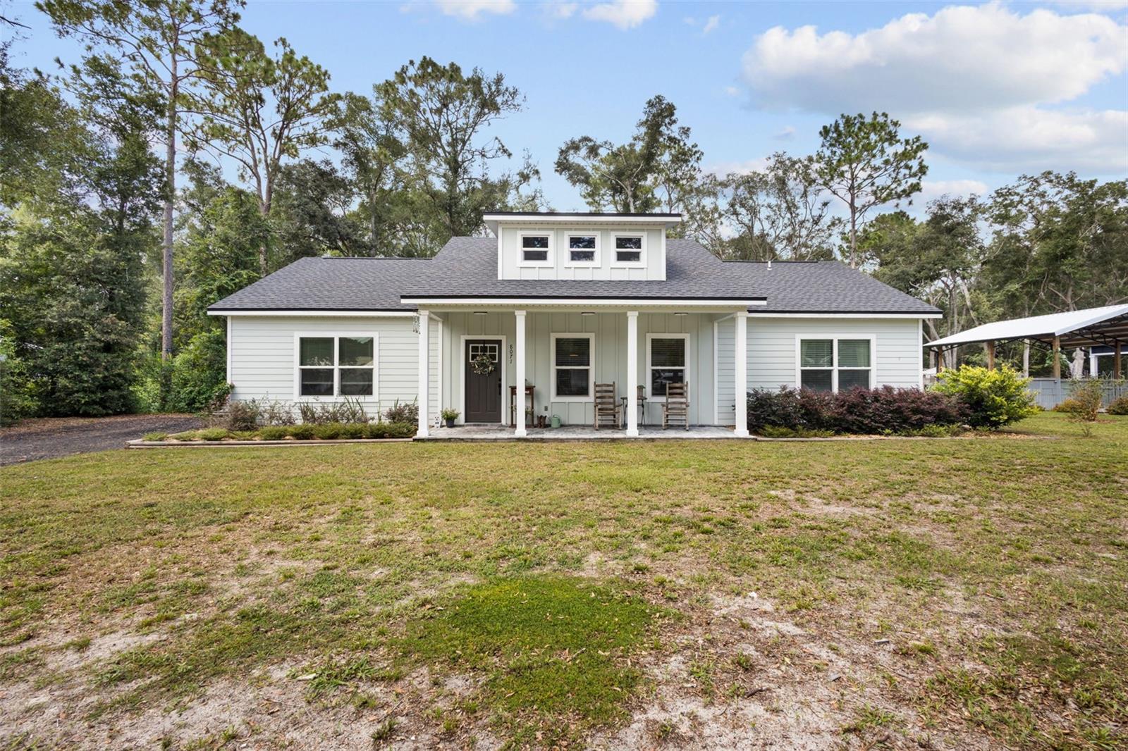 Welcome to this beautifully maintained 2024-built home in the desirable Silver Oaks neighborhood of Fanning Springs. Situated on a wooded half-acre lot, this 3-bedroom, 2-bath home offers privacy, modern finishes, and a peaceful North Florida setting. A spacious front porch, attractive fiber-cement siding and trim, landscaped yard, and millings driveway create inviting curb appeal. Inside, the bright and open floor plan features 9-foot exterior walls, a cathedral ceiling in the great room, abundant natural light, and luxury vinyl plank flooring throughout the main living areas. The kitchen is designed for both everyday living and entertaining, with wood cabinetry, granite countertops, stainless steel appliances, and a large center island with a snack bar. The spacious primary bedroom includes a tray ceiling and private en-suite bathroom featuring granite countertops, dual undermount sinks, and a tiled shower. Two additional generously sized bedrooms provide flexibility for family, guests, or a home office. Enjoy the mature trees and private backyard from the rear patio. Conveniently located near Chiefland and within driving distance of Gainesville, the property also offers easy access to Fanning Springs State Park, the Suwannee River, area freshwater springs, and the Gulf Coast, including popular destinations such as Cedar Key. This move-in-ready home combines modern comfort, natural surroundings, and convenient access to the best of Florida’s Nature Coast.