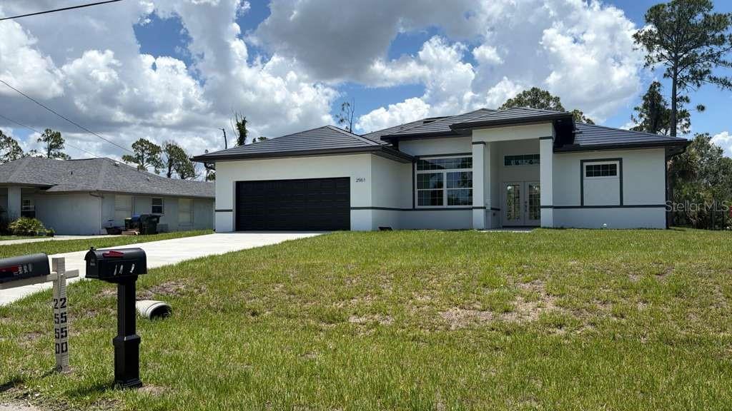 Brand-New Construction Home with Outdoor Kitchen in North Port

Welcome to this stunning new construction home in the rapidly growing community of North Port, where modern design, quality craftsmanship, and thoughtful features come together to create the perfect place to call home. Offering 4 spacious bedrooms, 2 full bathrooms, and an open-concept layout, this home is designed for comfortable everyday living and effortless entertaining.

Step inside and be greeted by soaring high ceilings and an abundance of natural light that enhance the home's spacious feel. The expansive living and dining areas flow seamlessly together, creating a bright and inviting atmosphere ideal for family gatherings, holiday celebrations, or simply relaxing at home.

The beautifully appointed kitchen serves as the heart of the home, featuring solid wood cabinetry, elegant stone countertops, and a full set of included appliances. With ample workspace and storage, this kitchen combines style and functionality for any home chef.

The private primary suite offers a peaceful retreat with a large walk-in closet and a well-designed en-suite bathroom. The additional bedrooms are generously sized and include built-in closets, providing plenty of storage and flexibility for family members, guests, or a home office.

One of the standout features of this property is the incredible outdoor living space. Step outside to a covered patio designed for year-round enjoyment, complete with an outdoor kitchen, built-in grill, and ceiling fan. Whether you're hosting weekend barbecues, entertaining friends, or enjoying a quiet evening outdoors, this space is sure to become a favorite gathering spot.

Additional highlights include a spacious attached two-car garage, modern finishes throughout, and the peace of mind that comes with owning a brand-new home.

Ideally located near major roadways, shopping, dining, and highly rated schools, this exceptional property offers both convenience and lifestyle. Don't miss the opportunity to own a beautifully crafted new construction home with premium indoor and outdoor living spaces in one of North Port's most desirable areas.

Schedule your private showing today and experience everything this remarkable home has to provide.
