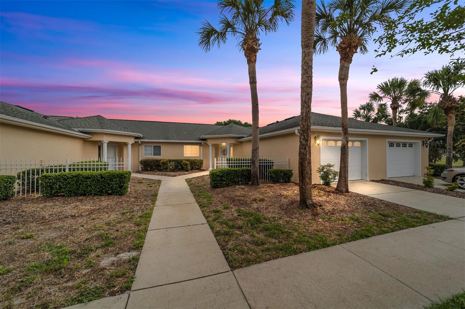Unique opportunity to bring your toothbrush and golf clubs for a turn-key 2 bedroom, 2 bath townhouse on the golf course in a sought after 55+ community. Completely move in ready with new LVP flooring and beautiful furniture. This home is bright land sunny throughout with panoramic views of golf course and golf club house. The kitchen offers plenty of counter space and cabinets, with pantry and stainless steel appliances. Primary bedroom is spacious with sliders out to Florida room and large walk-in closet. updated tile shower and  extra storage cabinet in bathroom. The garage is 1 and 1/2 car with space for a golf cart. Additional living area provided from a comfortable Florida room that offers views of the 18th fairway. HVAC 2024, Water Heater 2025, Spruce Creek Community is an active, gated community nestled into 4000 acres of Ross Prairie Nature Preserve giving us a quiet country atmosphere, while still offering lots to do within the community. Lots of fun activities including access to golf course by golf cart, pickleball, tennis, water aerobics, heated pool/hot tub, shuffleboard, corn hole, horseshoes, fitness center, yoga, chair volleyball, billiards, games/cards, crafts, Bingo, bunco, potluck  dinners, dances, social/travel groups and more.  Less than 5 miles from groceries, pizza, restaurants, shopping, gas, banking, hospitals, doctors and miles of nature trails for biking and hiking. Looking for more Florida fun? There are opportunities for visiting the World Equestrian Center, fishing on the Gulf, Kayaking on the Rainbow River or Silver Springs, Daytona Beaches or swimming with the manatees in Crystal River.