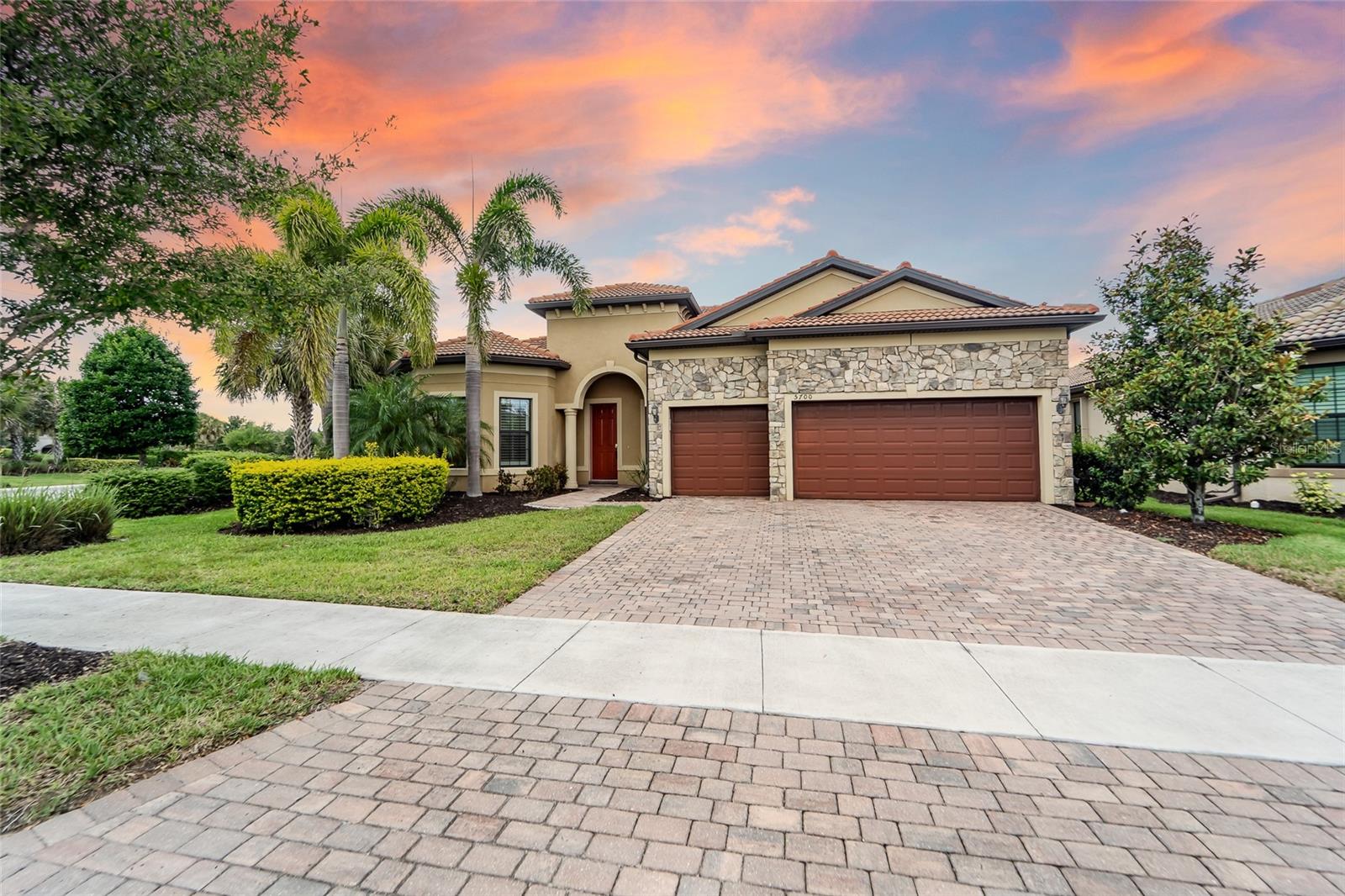 Virtually Staged. Located in the highly sought-after gated community of Hammock Preserve on Palmer Ranch, this beautifully designed 3 bedroom, 3 bathroom home offers the perfect blend of luxury, comfort, and location. Walking through the front door, be greeted by stunning water views that create a peaceful and inviting atmosphere throughout the main living space. Find ultimate flexibility for living with all bedrooms split and two featuring ensuite baths, walk-in closets with custom closet systems.

Designed with both style and functionality in mind, this home features a spacious open-concept floor plan, plantation shutters, custom millwork, and a 3-car garage with epoxy flooring offering plenty of storage space. The chef’s kitchen is truly the heart of the home, complete with a gas cooktop, large center island perfect for family gatherings or entertaining guests, abundant cabinetry, and seamless flow into the living and dining areas.

Guests can easily transition outside to the large, enclosed lanai, already plumbed for an outdoor kitchen. Make this the ideal place to relax and enjoy the peaceful water views year-round. Whether hosting friends or enjoying a quiet evening at home, this outdoor space perfectly captures the Florida lifestyle.

Enjoy resort-style living just minutes from world-renowned beaches, shopping, dining, golf, and everything Sarasota has to offer. Hammock Preserve provides resort style living with its state-of-the-art clubhouse, resort-style pool, fitness center, Har Tru tennis courts, pickleball, bocce ball, fire pit, and a dog park, all within a secure gated community. 5700 Sweet Leaf Way combines luxury finishes, thoughtful design, and an unbeatable location in one exceptional home.