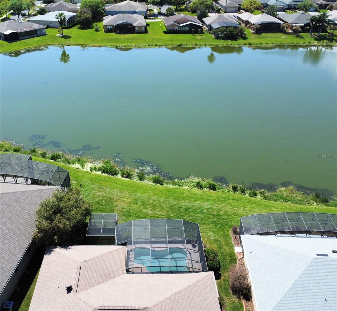 One or more pictures virtually staged. OUTSTANDING OPERETTA Model PRICED TO SELL with a heated POOL & SPA on a POND in the Terra Vista subdivision of Solivita. BEST VIEWS OF WATER in Solivita & CONSERVATION across the street.  HVAC new in 2017. Roof new in 2016. NINETEEN vinyl frame, DOUBLE PANE Low E (New South Windows) & THREE SLIDERS new in 2015. CERAMIC TILE FLOORS, 8' DOORs &  5 1/2" BASEBOARDS throughout. Front porch is screened and front door has a LEADED GLASS INSERT. Kitchen features Corian counters, RECESSED lights, PULL-OUT drawers in lower cabinets, 42" UPPER cabinets with CROWN MOLDING, APPLIANCES new in 2020 and PANTRY with PULL-OUT drawers. Primary Bedroom had two WALK-IN closets with custom shelving. Primary Bathroom has GRANITE counters, DUAL SINKS, CUSTOM extra cabinets & a HYDROTHERAPY tub. All THREE bathrooms have comfort height commodes with BIDETS. Second bathroom has a UPDATED WALK-IN shower & a linen closet. Lanai faces SOUTH & has SWEEPING POND VIEWS. POOL is 20' wide X 28' long and ranges from 3' to 5' deep. Pool & Spa are heated with a HEAT PUMP. Lanai has a Sunbrella-type RETRACTABLE shade. There also is a SCREENED DOG AREA w/ astroturf like flooring. Garage floor is painted with epoxy & confetti chips and it has a side access door.***Solivita is an active adult 55+ community located in Kissimmee, Florida. It is approximately 50 minutes from Disney World & the Orlando International Airport. Solivita has a total of 5,470 homes. Approximately 10,000 - 11,000 people live in Solivita during the winter while approximately 7,500 live in Solivita during the summer. Enjoy your active years in this piece of paradise. Solivita's amenities include: - a manicured SOFTBALL diamond & field - 36 holes of CHAMPIONSHIP GOLF that can be played by joining the Stonegate Golf Club or paying as you go - 2 STATE of the Art AMENITY centers with updated exercise equipment, yoga studio & meeting rooms - 3 restaurants - 14 HEATED POOLS - 17 PICKLEBALL courts - 9 TENNIS courts - 4 BOCCE BALL courts - 4 SHUFFLEBOARD courts - 3 HORSESHOE pits - a BILLIARDS room - miles of bike paths - 2 DOG PARKS (Small & Large Dogs) - Corn Hole - Tot Lot PLAYGROUND - COMMUNITY GARDEN - over 250 resident clubs. The HOA: - maintains the LANDSCAPING & IRRIGATION systems in the common areas as well as at individual homesites - maintains the roads throughout the community - PROVIDES SECURITY with gate guards and mobile patrols including the Polk County Sheriff - allows AUTOMATED GATE ACCESS for residents via license plate readers - provides residents with Fiber Optic Internet & TV service.***Poinciana Lakes Plaza is a MAJOR NEW SHOPPING CENTER that opened directly across from the Solivita Main Gate in Summer of 2024. It features Sprouts Grocery, TJ MAXX, Ross, Burlington, Rack Room Shoes, 5 Below, Ulta, Outback, First Watch, 5 Guys, Urgent Care, Dentist, TD Bank, Petco & Hair Cuttery PLUS MORE TO COME.***