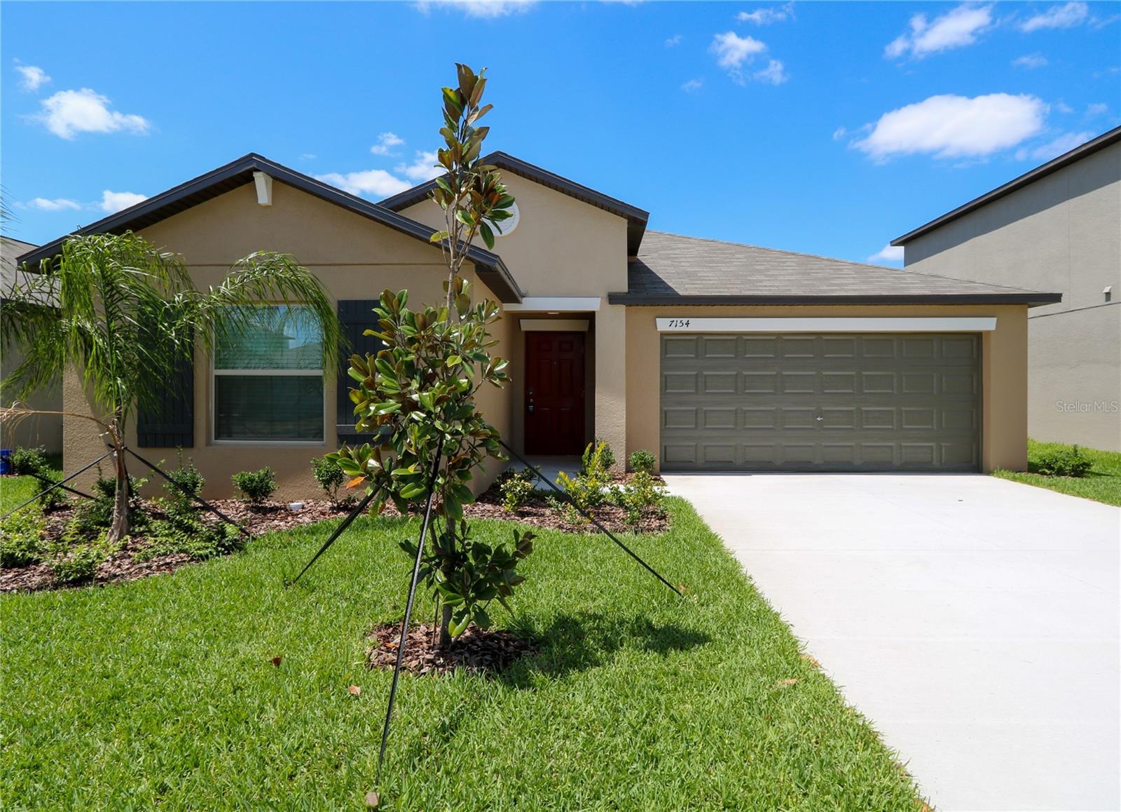 Welcome home to this spacious 4-bedroom, 2-bath, 2-car garage home located in the highly desirable Touchstone community! Offering 1,936 sq. ft. of thoughtfully designed living space, this home features a desirable split-bedroom floor plan with plush carpet in the bedrooms and tile flooring throughout the main living areas. The open-concept kitchen showcases a large center island overlooking the dining and family room, creating the perfect space for entertaining family and friends. The oversized primary suite offers a private retreat with dual vanities, a walk-in shower, and an expansive walk-in closet. Three additional bedrooms are conveniently situated at the front of the home and share a full bath. Relax and enjoy peaceful pond views from your backyard while soaking up the Florida sunshine. Touchstone residents enjoy resort-style amenities including a sparkling pool, splash park, playground, fitness center, and more. Conveniently located near I-4, I-75, and US-301 for easy access to MacDill AFB, Tampa International Airport, downtown Tampa, St. Pete, shopping, dining, and Gulf Coast beaches. Don’t miss the opportunity to make this beautiful home yours!