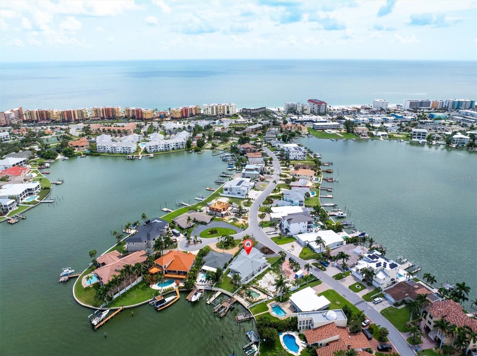 ULTIMATE BEACH LIVING! CHEF AND ENTERTAINERS DREAM with an abundance of storage space! Experience the pinnacle of coastal living in this BEAUTIFULLY RENOVATED, DEEP-WATER home. It sits in the perfect location of a PROTECTED COVE with NO BACK NEIGHBORS. Sitting on the famous Bath Club Blvd in the highly sought-after, friendly North Redington Beach neighborhood with all UNDERGROUND UTILITIES Including Natural Gas. As you enter through the custom vault style doors you can watch dolphins frolic, manatees explore, and mana rays jump while catching crab and fish from your own dock. The EXPANSIVE OPEN FLOOR PLAN blends natural light and modern convenience with a sleek design for a young family to grow and/or combine multi-generations. The wider doors and an easy roll-in shower allow as many options as any family may need. This home embodies a peaceful intimacy of happiness, sunshine, and the outdoors. The kitchen is a chef’s dream with a large central island with seating. The kitchen includes huge drawer storage, stainless-steel appliances: WOLF PROFESSIONAL 6 burner GAS Stove, Wolf Single Oven and Wolf Convection Microwave Combo, SUBZERO Built-in refrigerator, KitchenAid commercial style dishwasher, wine/drink refrigerator and reverse osmosis system. AND the “Back Kitchen” featuring a KitchenAid commercial style Double Oven, warming drawer, Ice Maker, Induction Cooktop as well as Optional Freeze Dryer or a matching wine/drink refrigerator, sink with garbage disposal and a second reverse osmosis system feeding all the ice making in the home. Making this home the perfect entertainer’s dream. In wall speakers both inside and out that Bluetooth to your device. The Primary Suite is separated from the other living areas and has ample space to enjoy. It boasts a large shower, and jetted tub stub-out ready for your new soaker or jetted choice, double sinks and separate lavatory. The Second ensuite boasts a coffee bar, large walk-in closet and a separate entrance/exit to a beautiful side yard with brick pavers and artificial grass makes a peaceful private spot or a perfect dog run. The third ensuite is beautiful and has its own elegant mini chandelier and custom tiling in the bathroom. There is an extra-large, indoor laundry room with storage space, sink, and an oversized washer and gas dryer. Also features an extra-large counter and a Whole Home Dehumidifier. Included are QUARTZ COUNTERTOPS
throughout the house, 2 natural gas powered INSTANT HOT WATER systems for each side of house, Plantation Shutters, and a Banko Insulated and Hurricane-Grade Garage Door with Camera. Wiring and Controls are ready to go for a Whole House Generator. The outdoor oasis features Deep Water with DIRECT ACCESS TO THE GULF and NO FIXED BRIDGES. Additional features are, concrete, capped seawall, dock with electric and fresh water, newly wrapped 10K boat lift, privacy fence, expanded porch, circular driveway, additional parking pad behind fence. There is a half bath outside with shower head/drain plumbing. A gas line is in place for a fire pit and a pool. North Redington Beach sits on higher topography than surrounding areas. This home does not disappoint with so many high-end extras it’s sure to sell quickly.