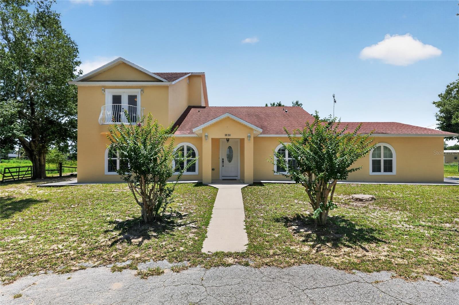Welcome to this exceptional 4.95-acre estate property in the highly desirable Lady Lake area of Lake County. Offering the perfect blend of privacy, space, and country living, this beautifully remodeled home was completely renovated and finished in 2010, providing updated features while maintaining its timeless charm.

The spacious home offers a comfortable layout with generous living areas, abundant natural light, and a peaceful setting surrounded by mature landscaping. A standout feature of the property is the detached shop, providing excellent space for hobbies, storage, a workshop, equipment, or additional recreational use.

The nearly 5-acre property offers endless opportunities for outdoor enjoyment, gardening, animals, or future expansion. With no HOA, you'll enjoy the freedom and flexibility to make this property your own.

Conveniently located just minutes from The Villages, shopping, dining, medical facilities, and major roadways, this unique property offers the perfect combination of rural tranquility and everyday convenience. Whether you're looking for a primary residence, a private retreat, or an investment opportunity, this rare acreage property is one you won't want to miss.