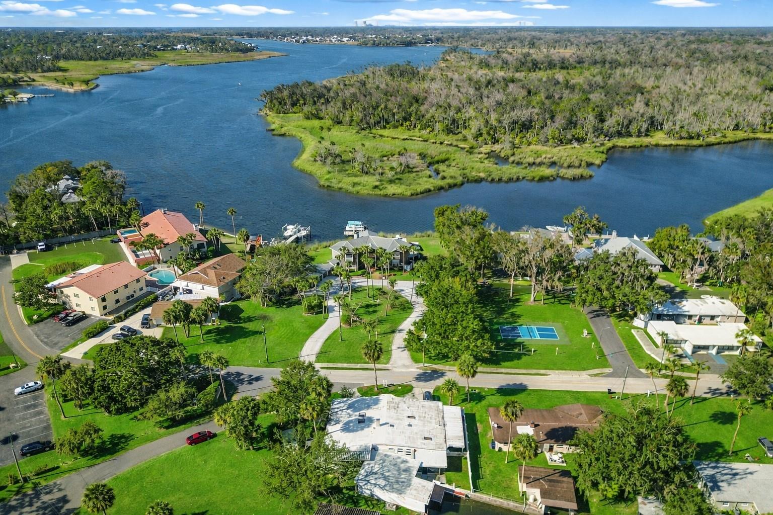 Welcome to life on the water at 421 NW 14th Place in Crystal River, where riverfront living meets small-town fun and flexibility you don’t usually find in one address. Whether you’re looking for a multi-generational home, a smart income-producing property, or a riverfront escape that actually lets you live the lifestyle, this one checks boxes you didn’t even know you had. The main living space offers three comfortable bedrooms, a full kitchen with new countertops, cabinets, and appliances, and tile flooring throughout—because river life should be easy to clean. A wood-burning fireplace adds just the right touch of cozy, while sliding doors lead you straight out to the covered lanai and boat dock. Morning coffee, sunset drinks, impromptu manatee sightings—this is the good stuff. Need room for guests, extended family, or income potential? You’ve got options. The second living area has its own private entrance, one bedroom, a full bath, and a complete kitchen with matching appliances, cabinets, and countertops—plus direct access to the lanai. Independent, comfortable, and perfectly positioned. Then there’s the cherry on top: the Captain’s Quarters. This studio guest house includes a kitchenette and full bath and feels exactly like it sounds—private, charming, and ready for visitors or rental income. Outside, the property keeps delivering: A laundry room connected to the lanai with plenty of storage. A full boathouse that can actually hold a boat (yes, really). Ample parking, a circular drive, garage and carport. Additional storage shed. The location seals the deal. You’re on crystal-clear freshwater, with views of the main river and just a short boat ride to the Gulf. Manatees, dolphins, and local wildlife are regular visitors—not occasional sightings. And when you’re ready to head into town? Downtown Crystal River is walking or golf-cart distance, with festivals, shops, and local dining always on the calendar.  Fair warning: once you pull up, you may not want to leave.