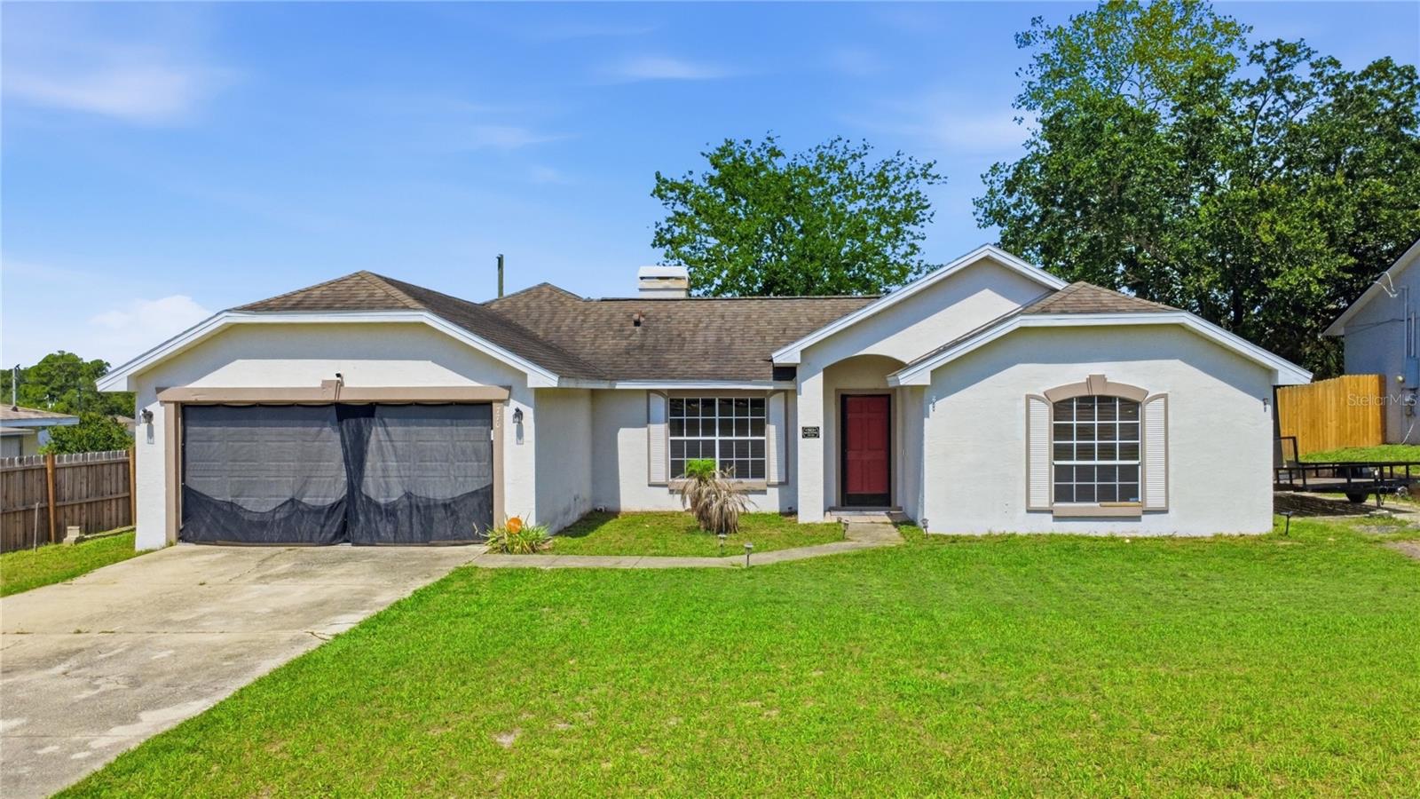 Welcome to this functionally, affordable home and nice neighborhood, perfect for Florida living!!! Offering a fantastic Deltona home, boasting 4 bedrooms, 2 baths, 2 car garage, and lots of living space. Ample living area, with living room and family room (including a cozy fireplace), a beautifully renewed kitchen with a gas range and eat in area, designated dining room, inside laundry, and a screened porch. Large rooms with a Jack and Jill bathroom for the primary and 2nd bedroom. This home boasts over 1700 square feet under A/C and over 2300 total square feet. Big yard with room to park a trailer or boat etc. NO HOA and in a beautiful neighborhood. Tons of options for shopping and adventures. Originally Deltona Lakes, there are many accessible lakes around for water fun, for manatee watching, mystical Blue Springs is 20 minutes West, historic Deland is 20 minutes North, some of the finest beaches are 30 minutes East, Orlando adventures are 30-45 minutes away and so many more amenities surround this great area. You will never NOT have something to do, see, or be involved in here. Come claim your piece of Florida paradise before it is gone!!! Call today for your showing before this one gets away! Great house with an awesome layout... priced for you to come make it your own.