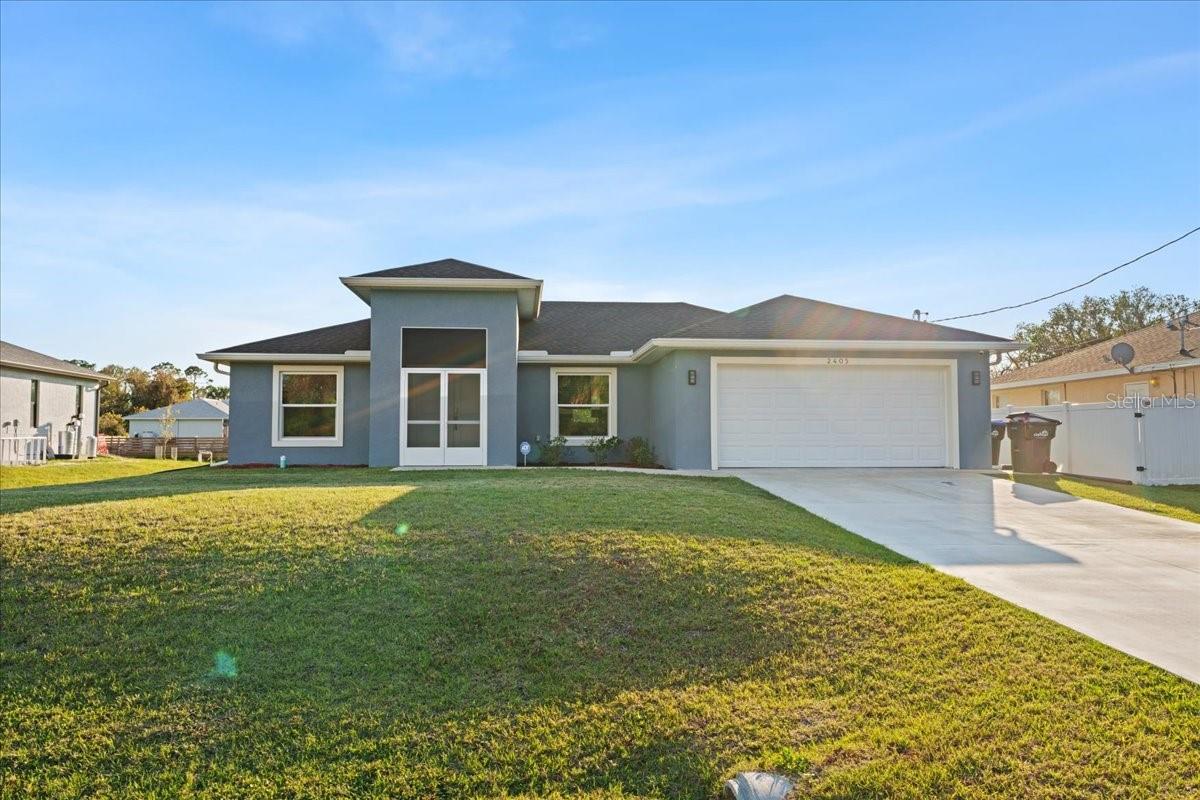 From the moment you step through the double-door entry, you're welcomed into a bright and spacious home designed for modern living. The open-concept, split floor plan immediately draws you in, with vaulted ceilings and recessed lighting enhancing the airy feel. The gourmet kitchen is a chef’s dream, featuring soft-close wood cabinets, quartz countertops, a tile backsplash, and an upgraded sink with a garbage disposal. The touchless faucet adds convenience, while the microwave’s vent fan directs air outside, keeping the space fresh. The home is also equipped with a reverse osmosis system, providing clean and purified drinking water right from the tap. The kitchen seamlessly flows into the dining and living areas, making it perfect for entertaining. The living area is the heart of the home, featuring a stunning electric fireplace positioned perfectly under your TV. With LED lighting options, you can set the ambiance for any season—whether it's a cozy winter evening or a stylish accent year-round. Just off the main living space, French doors lead to the screened lanai, where you can enjoy peaceful views of the greenbelt, providing extra privacy and space. The master suite is tucked away for tranquility, boasting a tray ceiling, a spacious walk-in closet, and an ensuite bath with dual sinks and a beautifully tiled shower. On the other side of the home, additional bedrooms and a second full bath provide comfort for family or guests. You'll also find a dedicated indoor laundry room, adding everyday convenience. Throughout the home, waterproof luxury vinyl flooring offers durability and style. Built in July 2023, this home is equipped with hurricane-impact windows for added security and energy efficiency. Plus, an additional capacitor for the air conditioning unit ensures improved performance and reliability, keeping your home cool even in the hottest months. With thoughtful upgrades and a prime location, this home is move-in ready. Schedule your showing today!